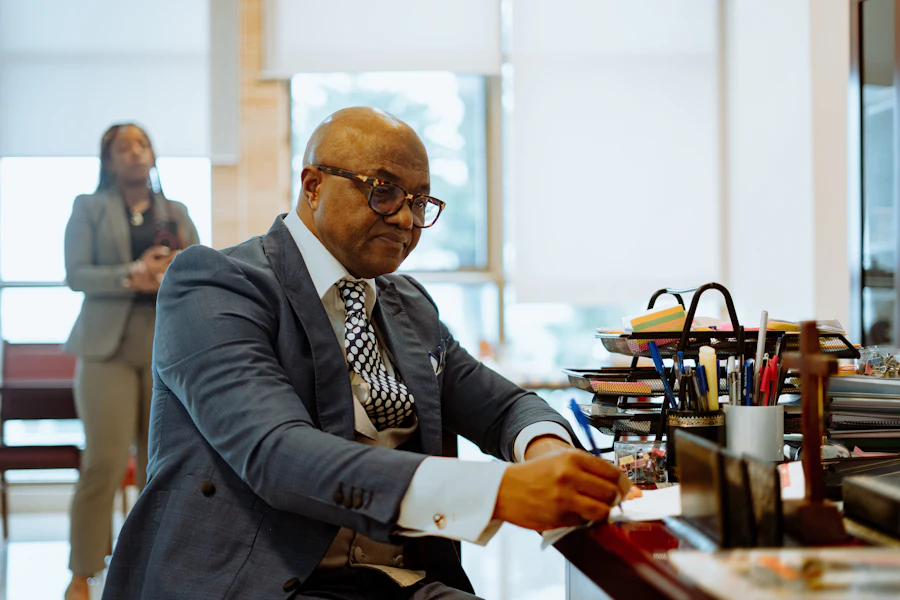 An adviser writing at a desk with a client