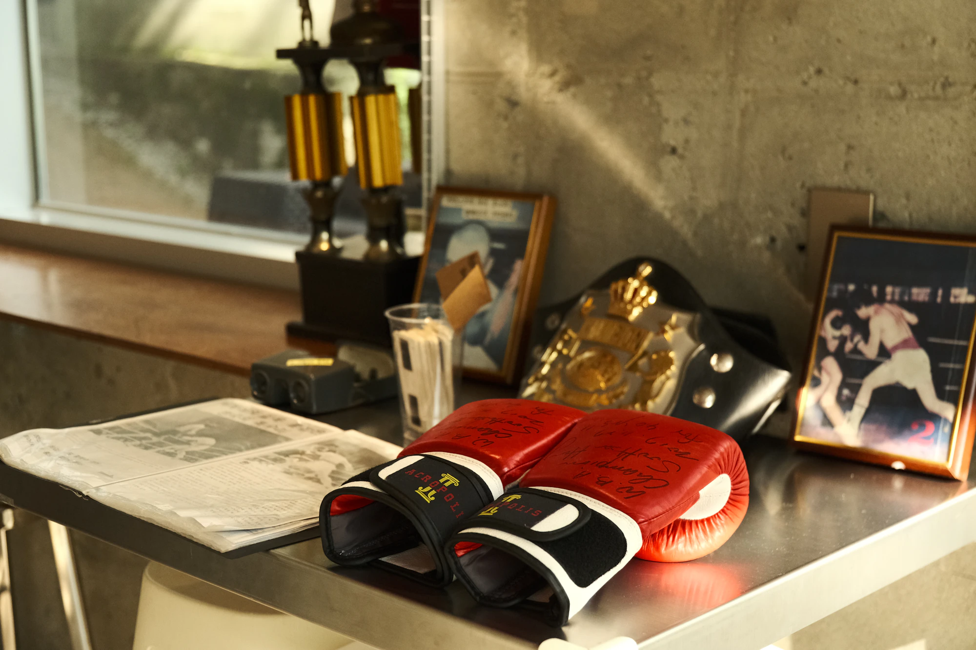 Championship belt with boxing gloves and trophies