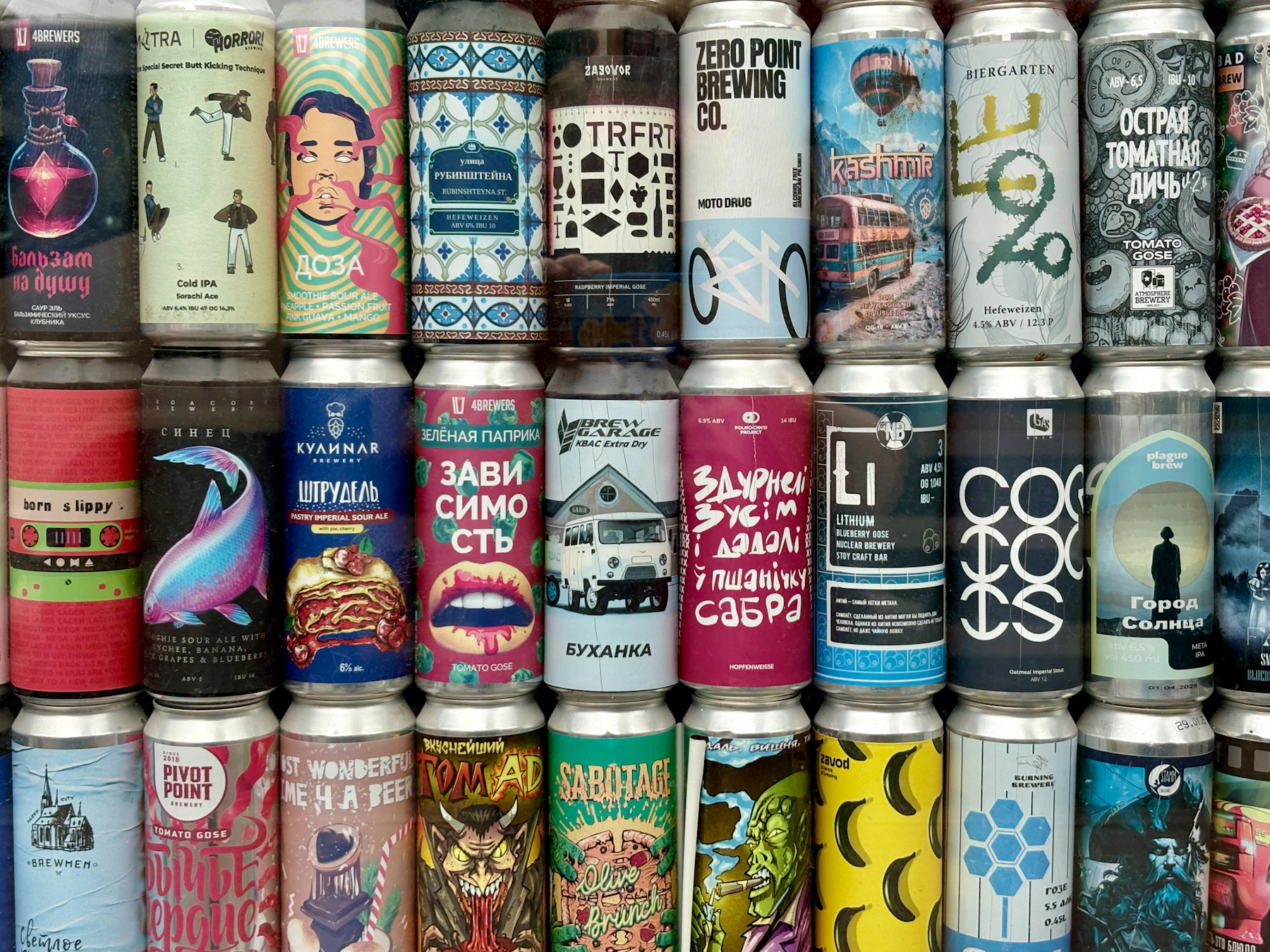 A grid of craft beer cans with illustrated labels, stacked three rows deep