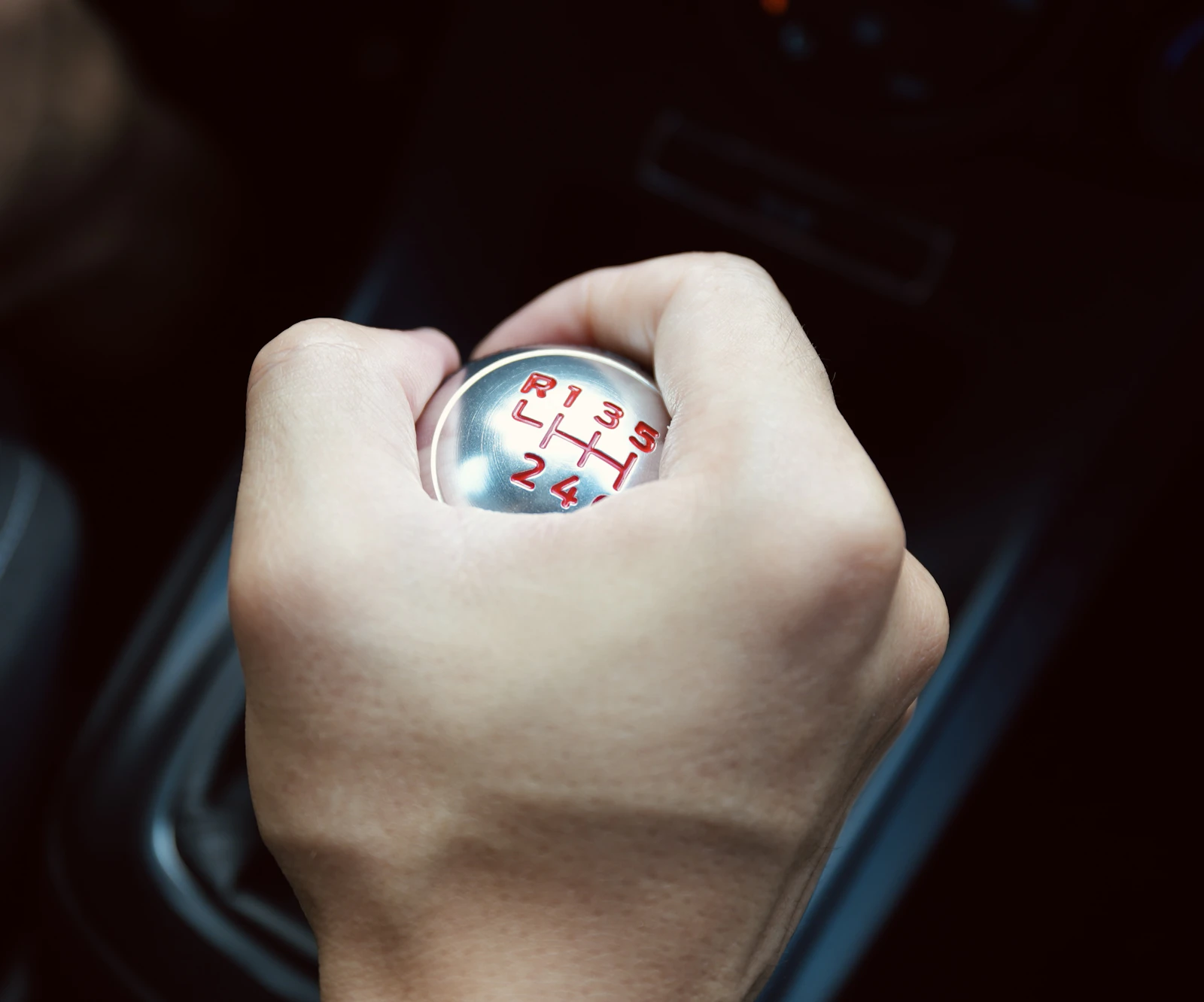 A hand on a manual gear knob
