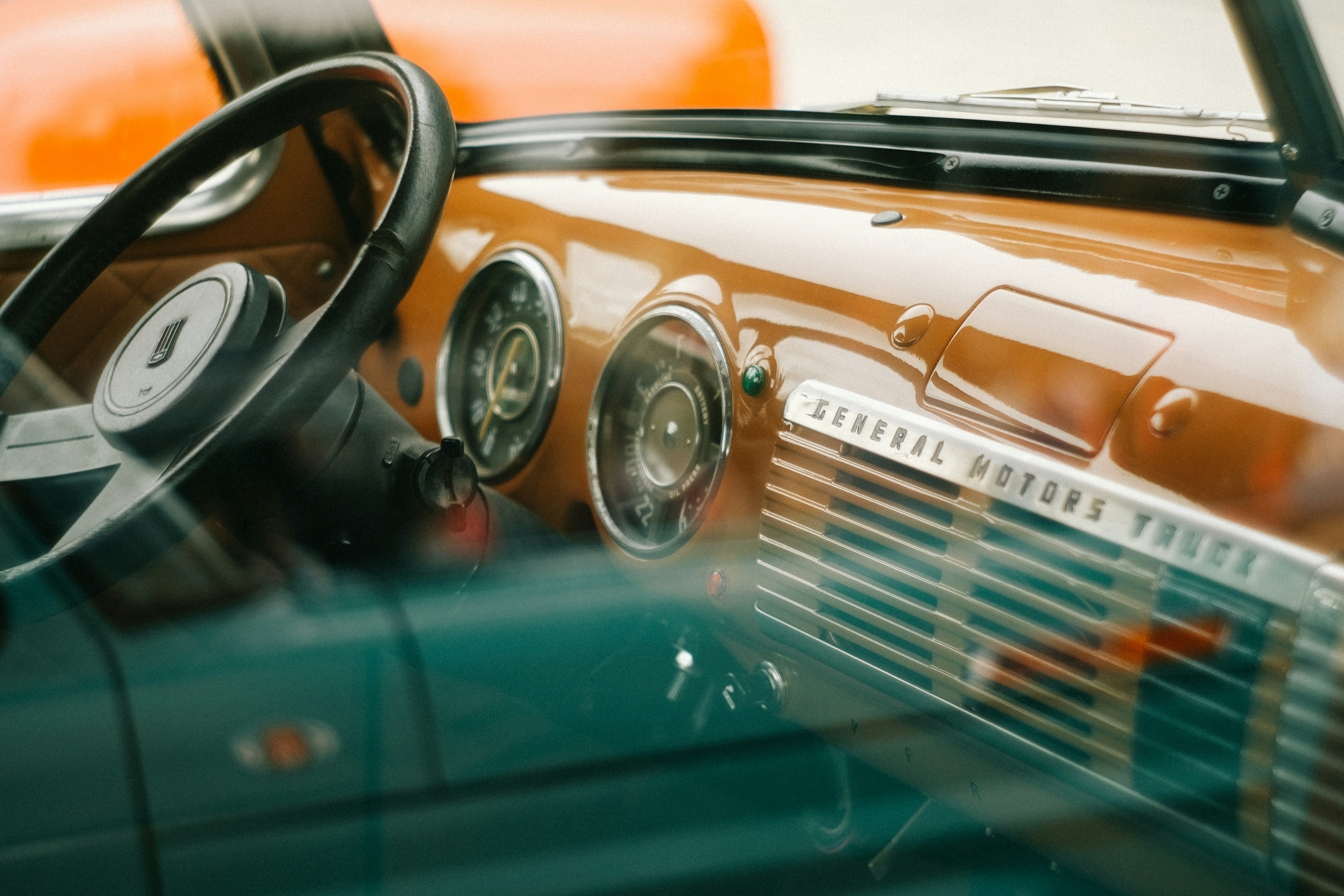 The interior dashboard of a vintage General Motors truck with circular gauges