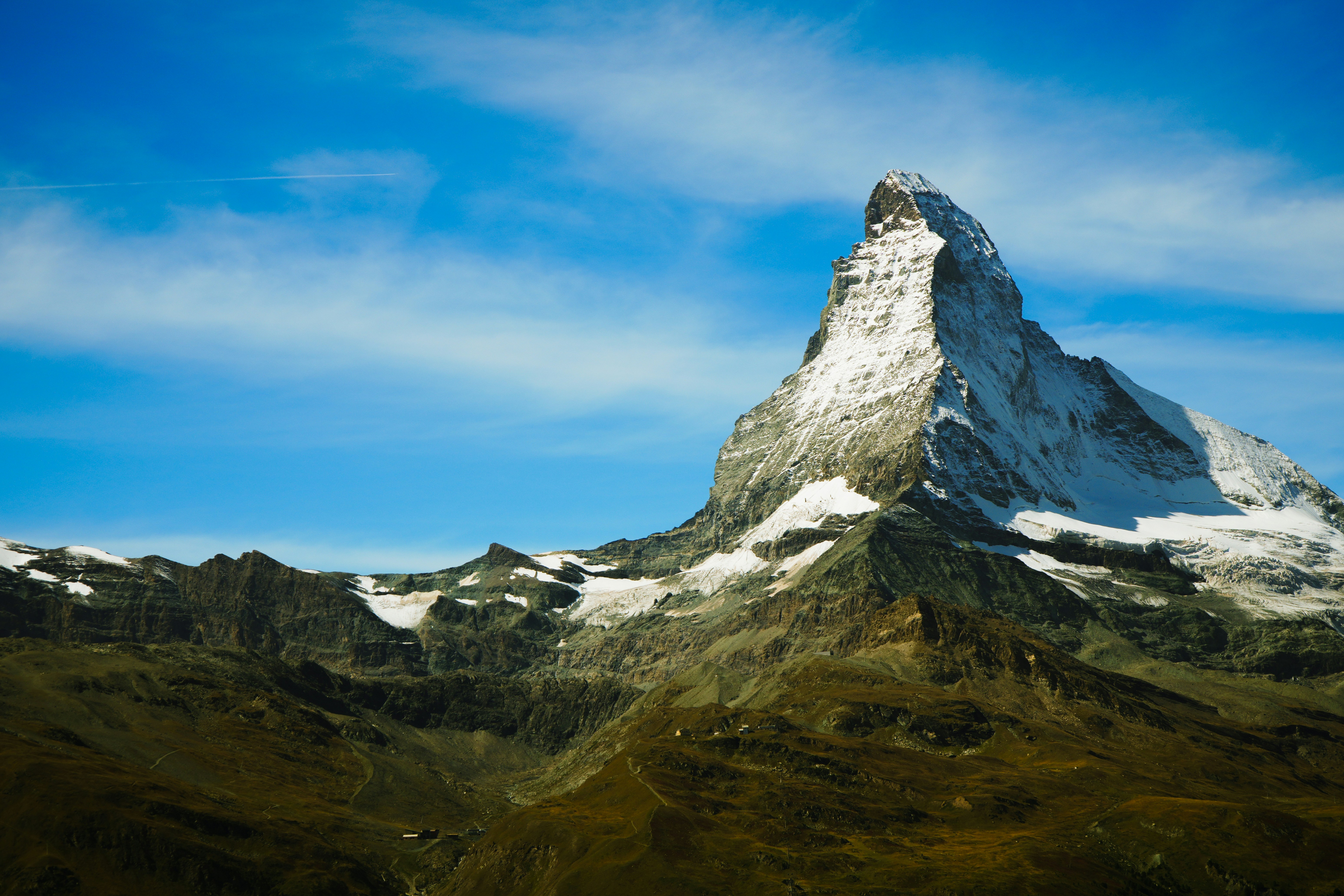The Matterhorn mountain peak with snow against a bright blue sky in Zermatt