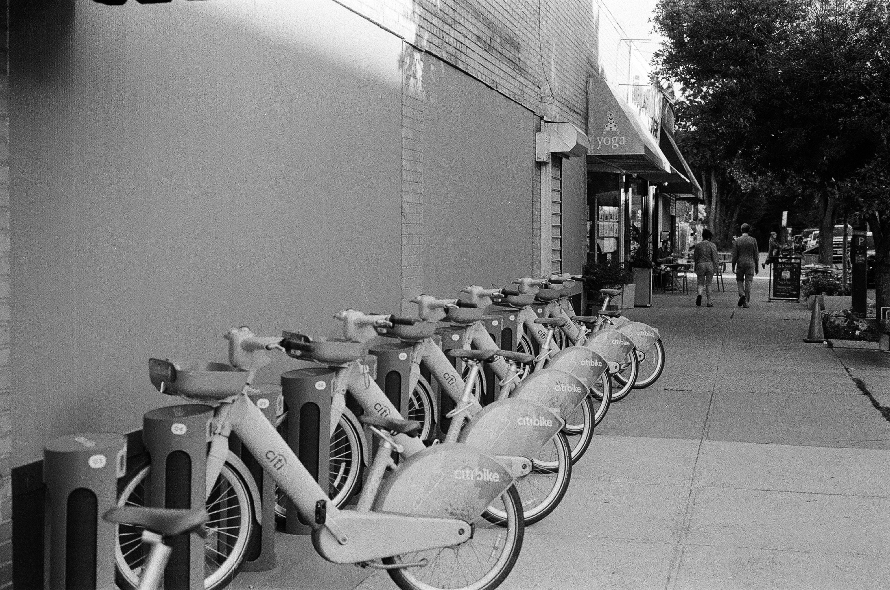 A row of Citi Bike rental bicycles parked on a city sidewalk