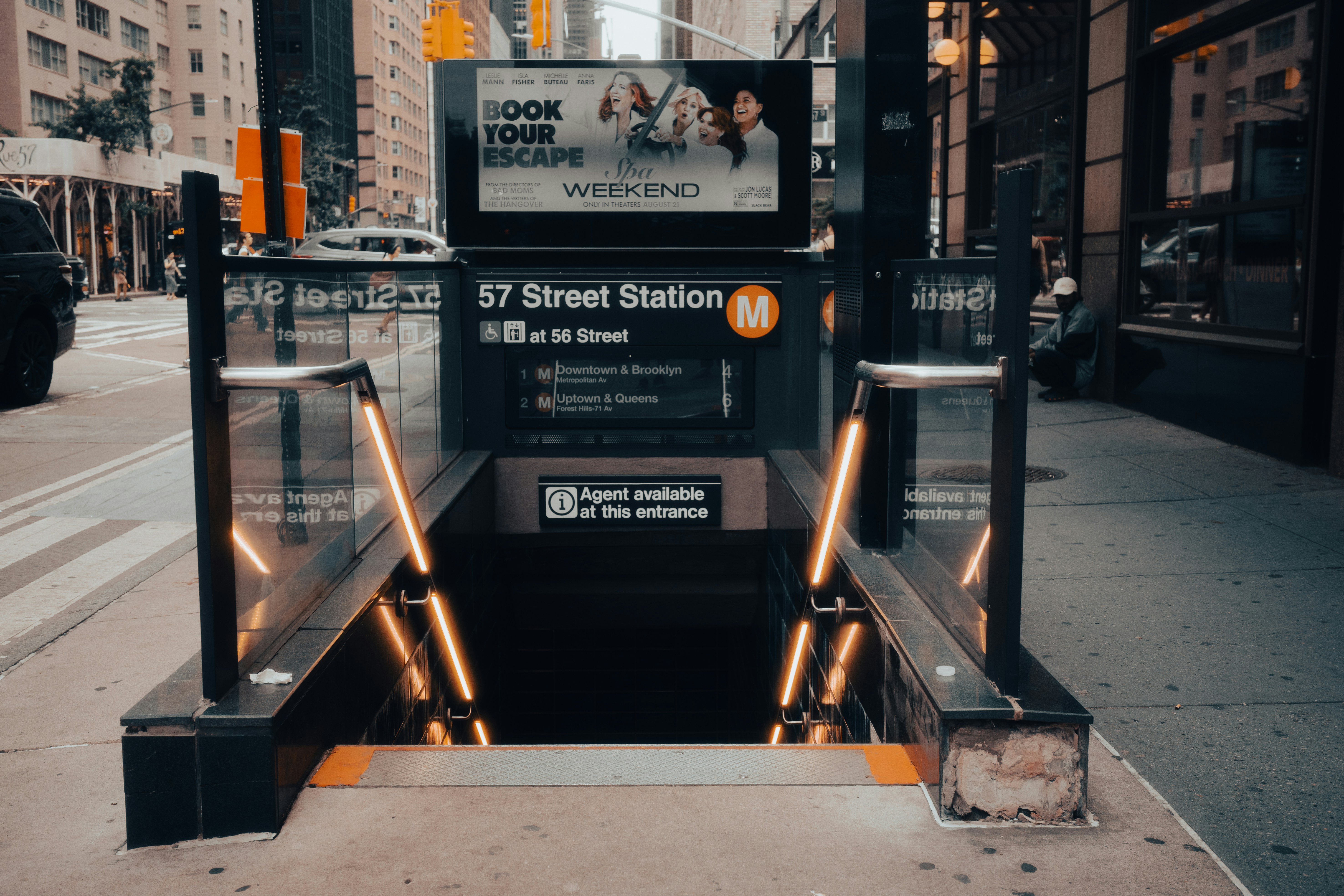 The 57 Street Station subway entrance with illuminated handrails on a New York sidewalk