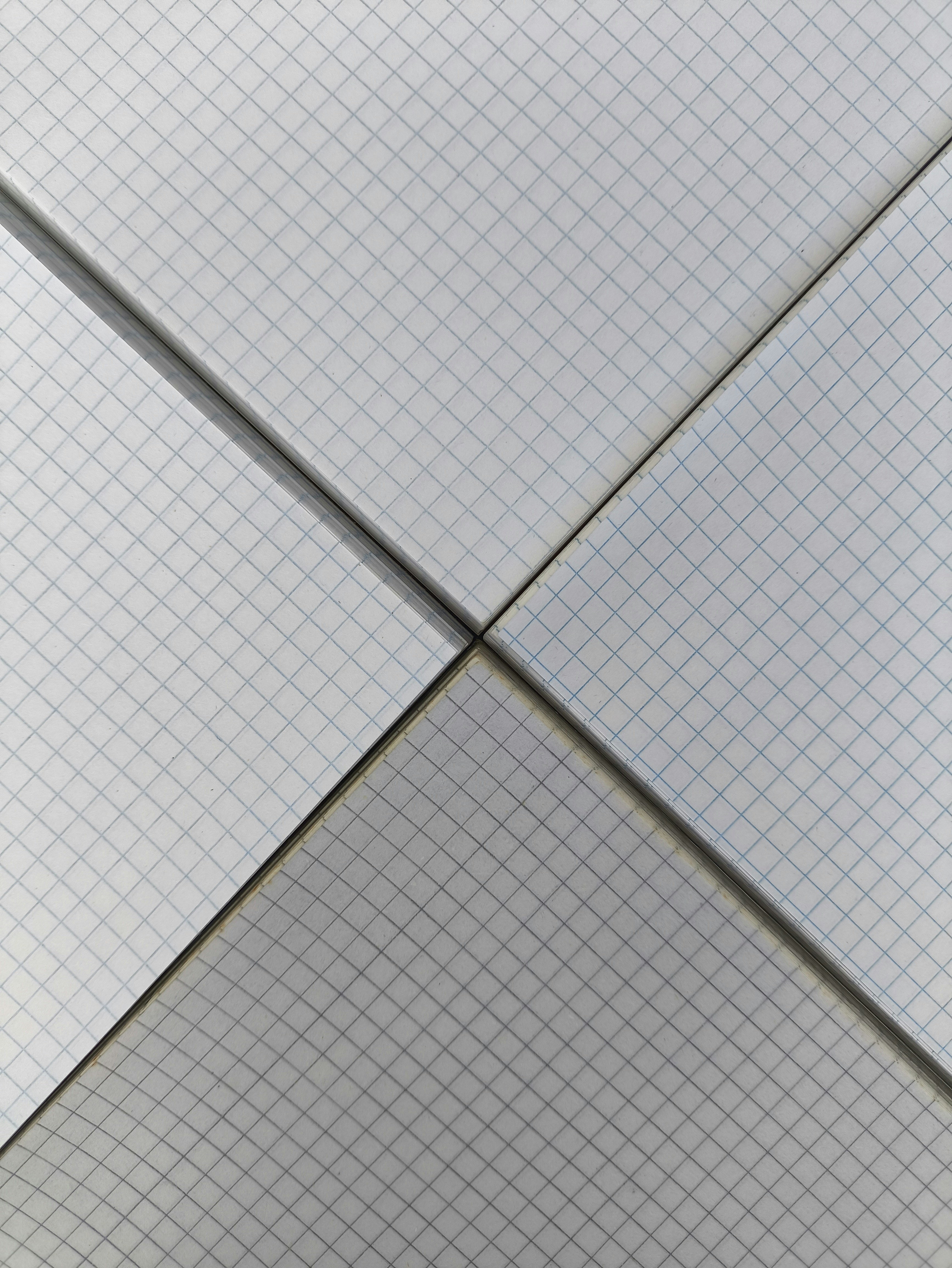 Four square panels with blue grid lines meeting at a central intersection