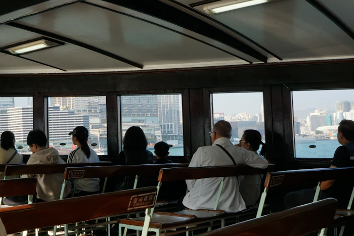 Passengers on a Star Ferry looking across the water at the Hong Kong skyline