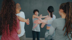 A group of people stretching their arms in a fitness class