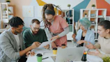 A group of people collaborating on documents at a table in a workspace