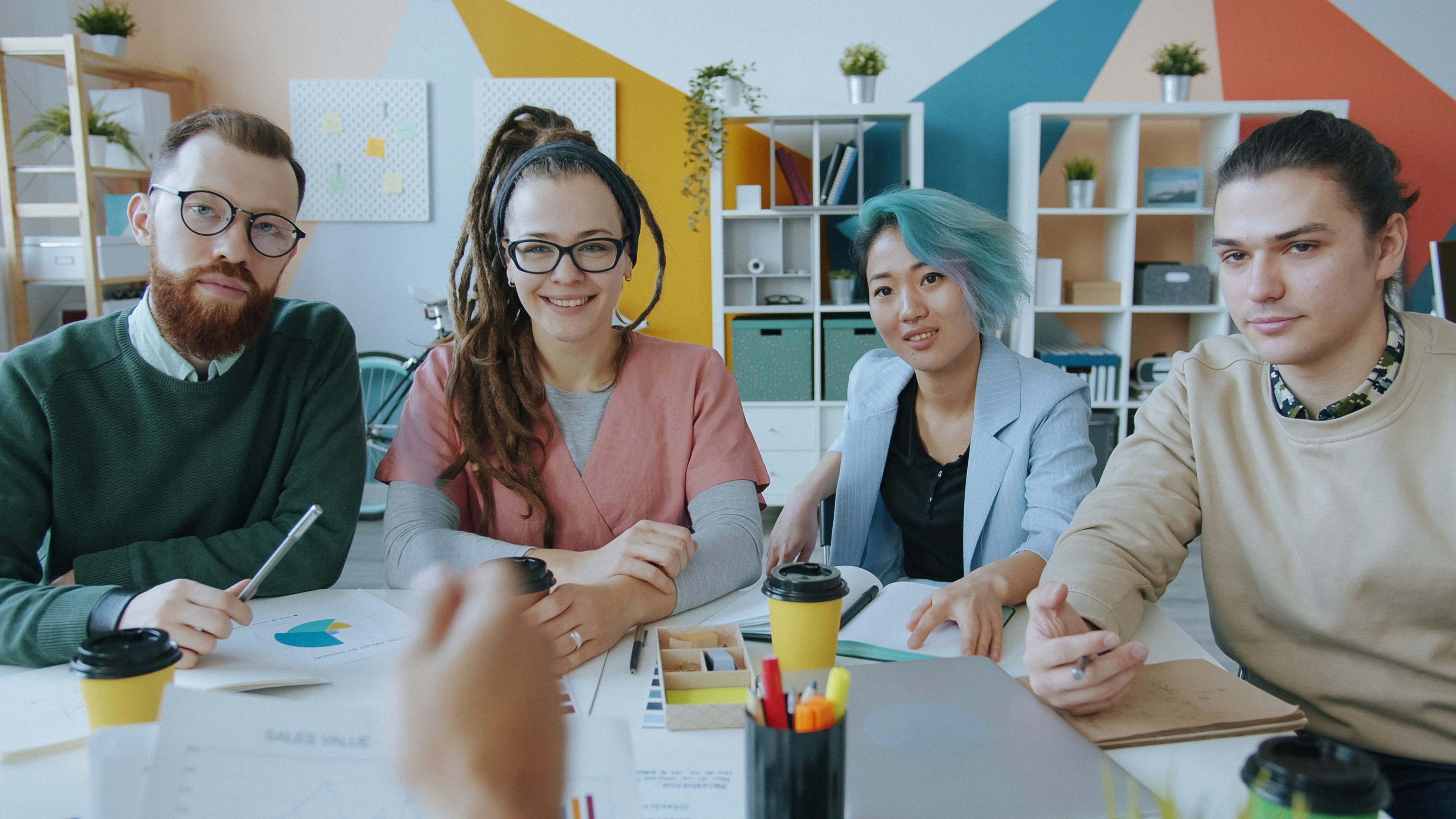 Creative team planning a campaign around a desk