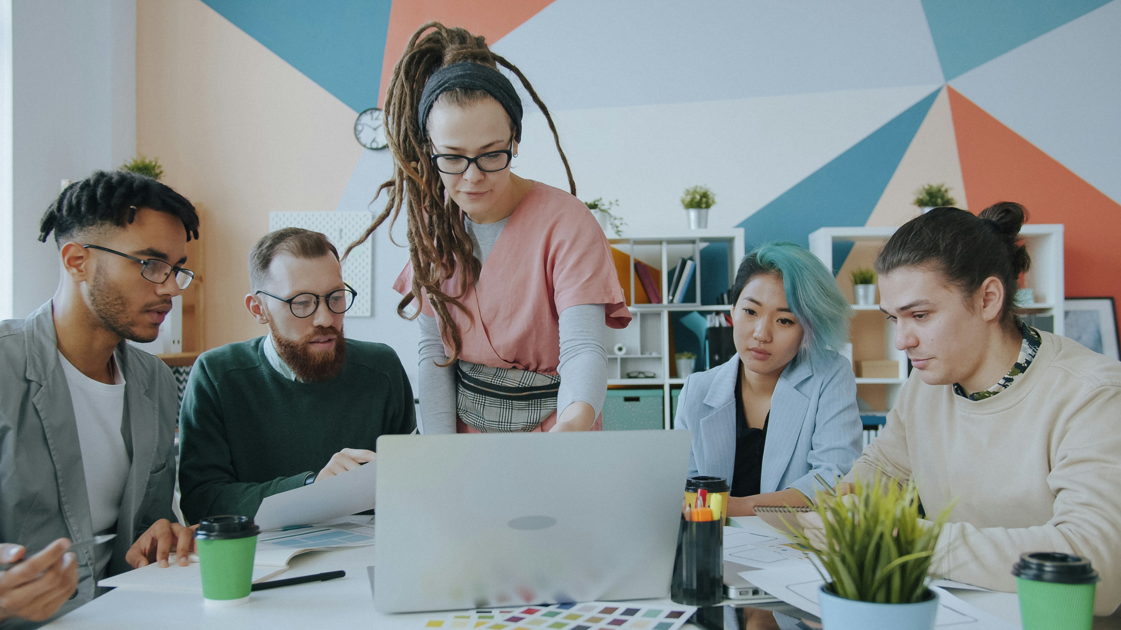 A diverse group of people collaborating on a project at a workspace