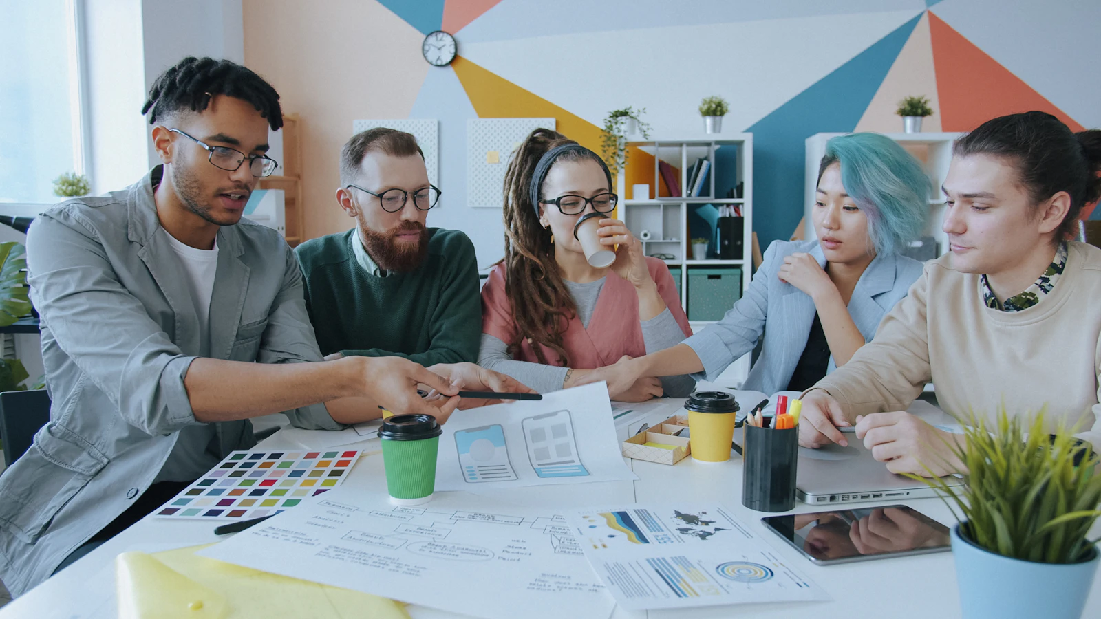 A team reviewing design work around a table