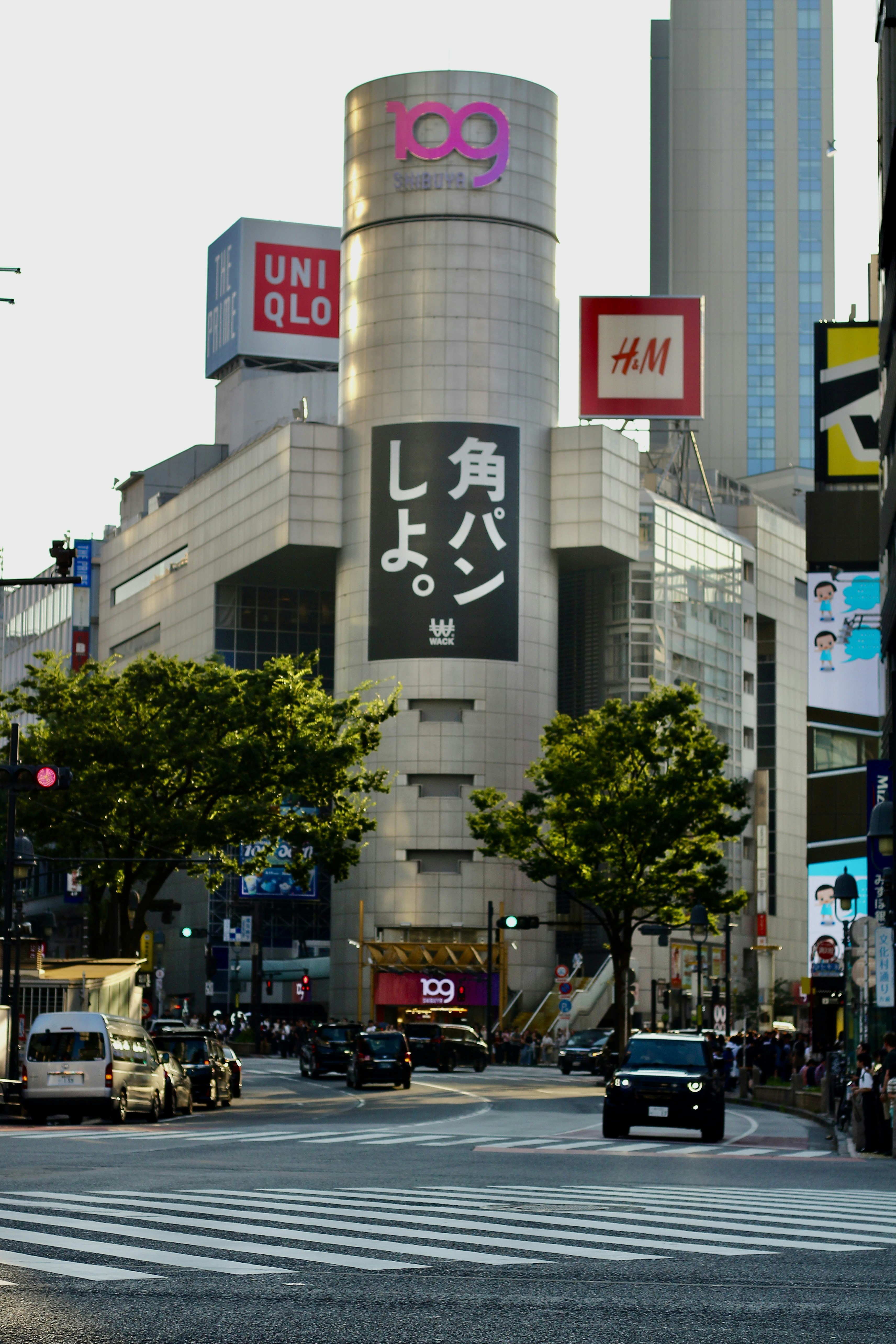 The Shibuya 109 building with large advertisements at a busy intersection in Tokyo