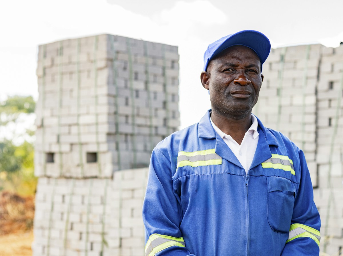 Worker in a blue work uniform and cap