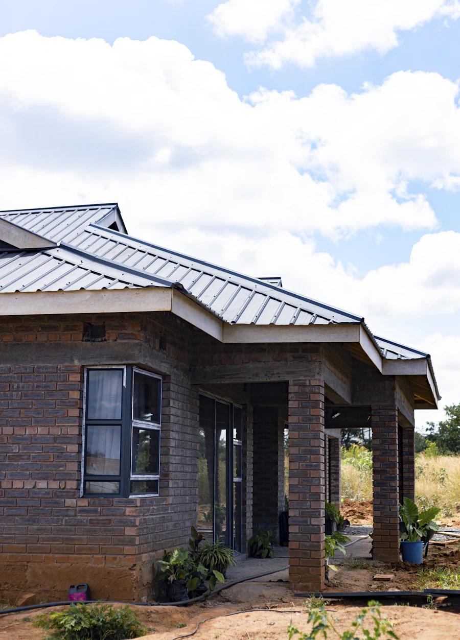 A brick house with a grey metal roof