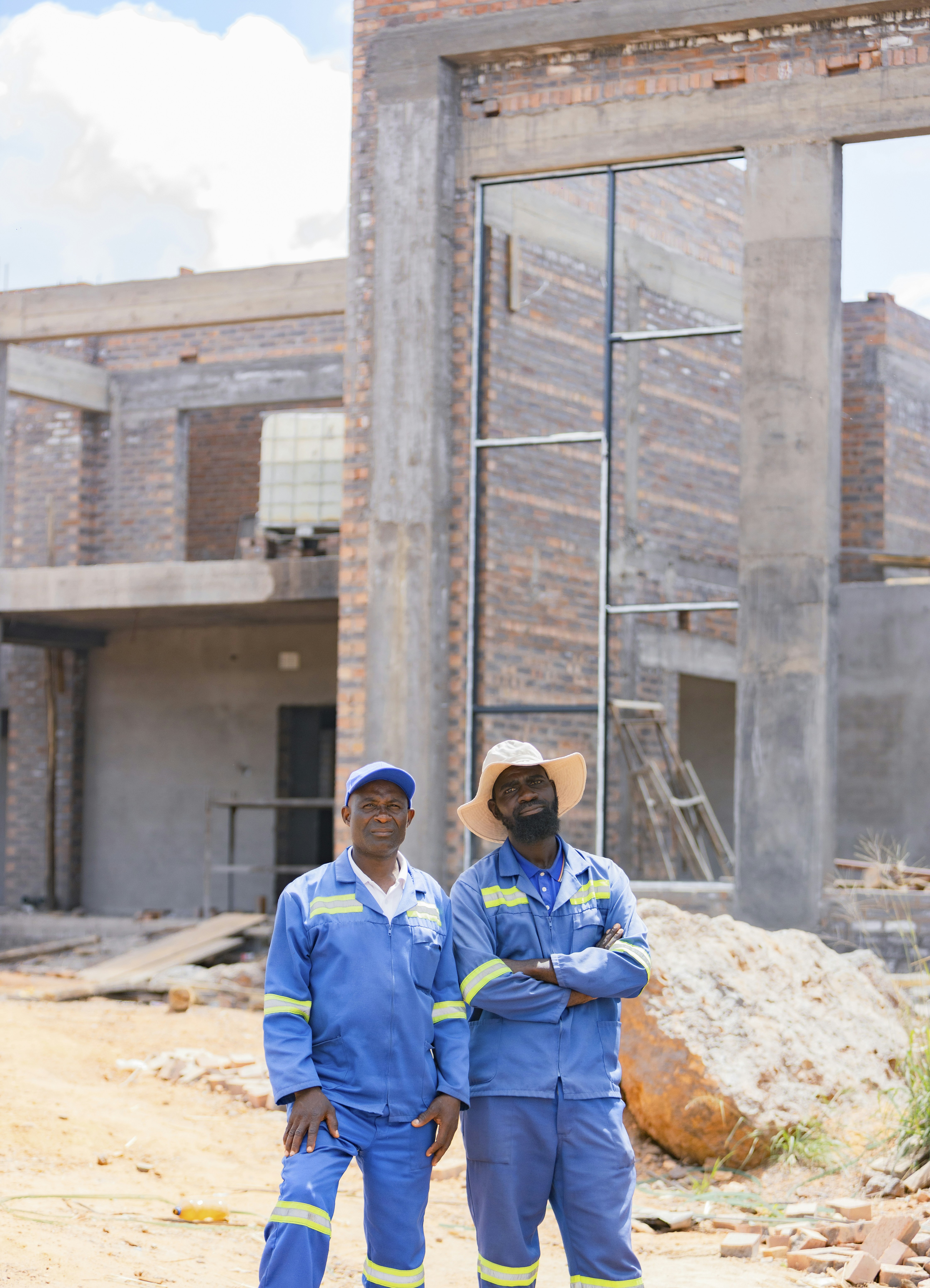 Builders Group and Design crew working on a building site with brick walls