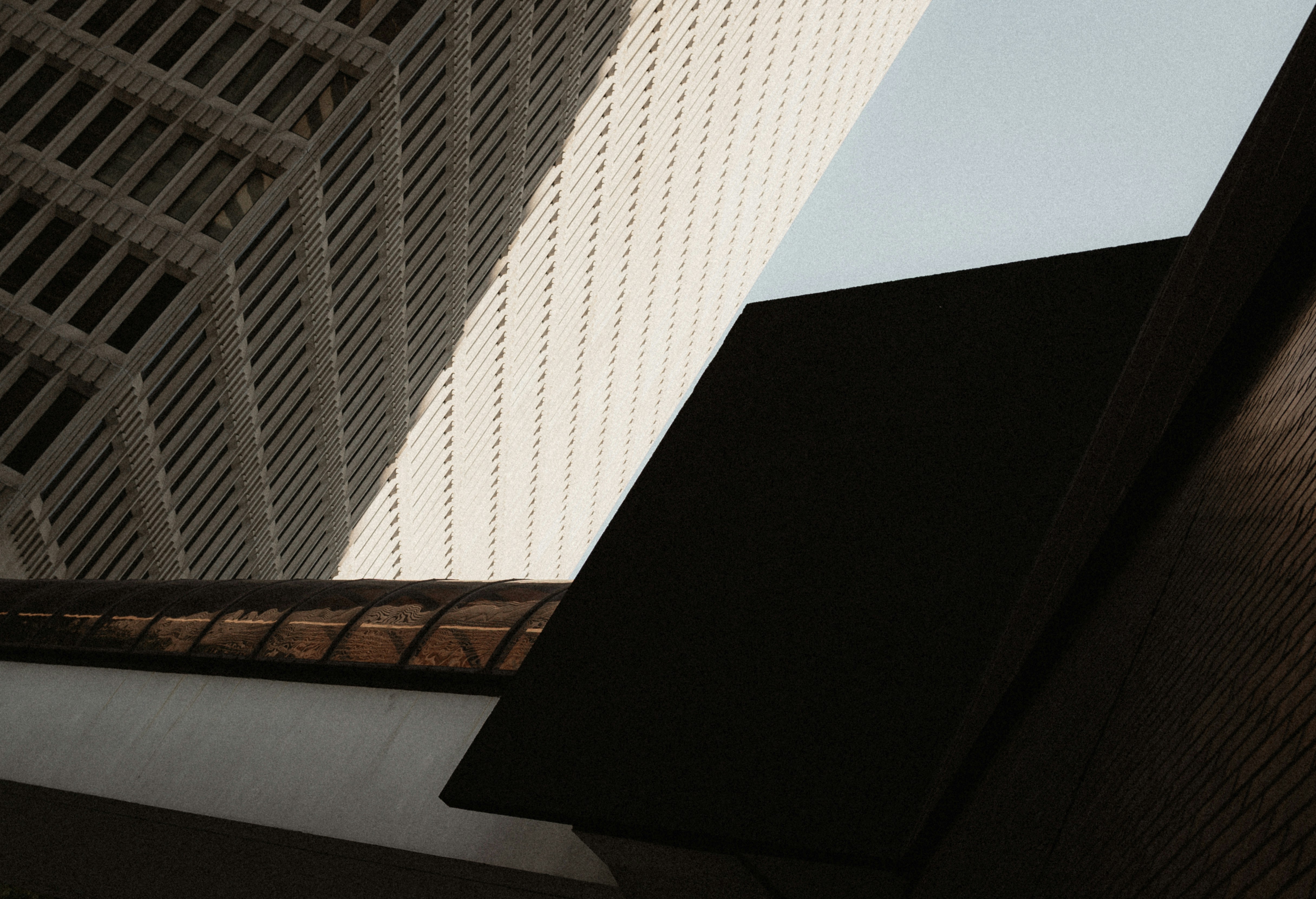 Geometric architectural forms of skyscrapers against a clear blue sky