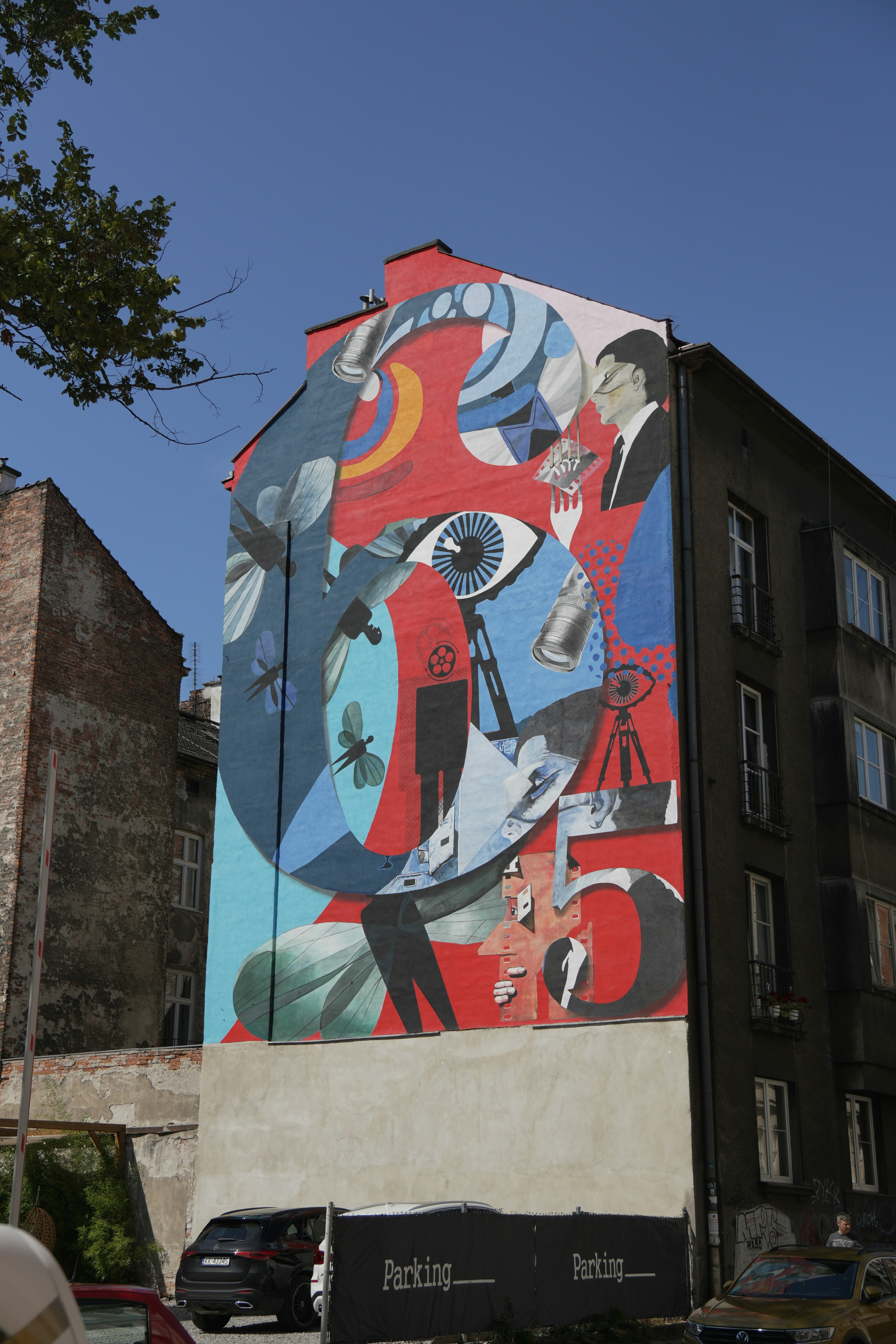 A large colorful mural featuring the number sixty-five on the side of a building