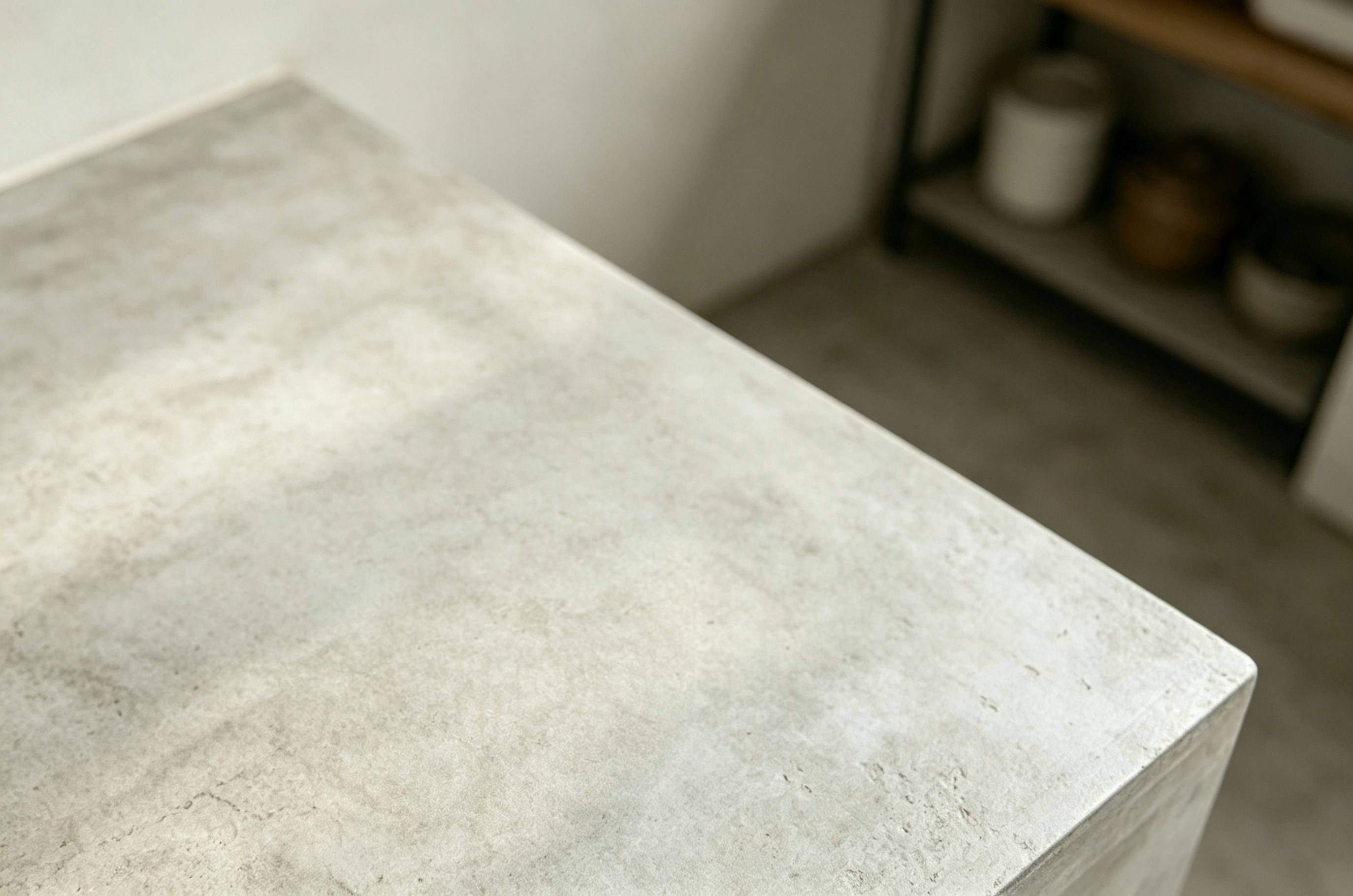 A light grey concrete countertop with a textured surface in a kitchen