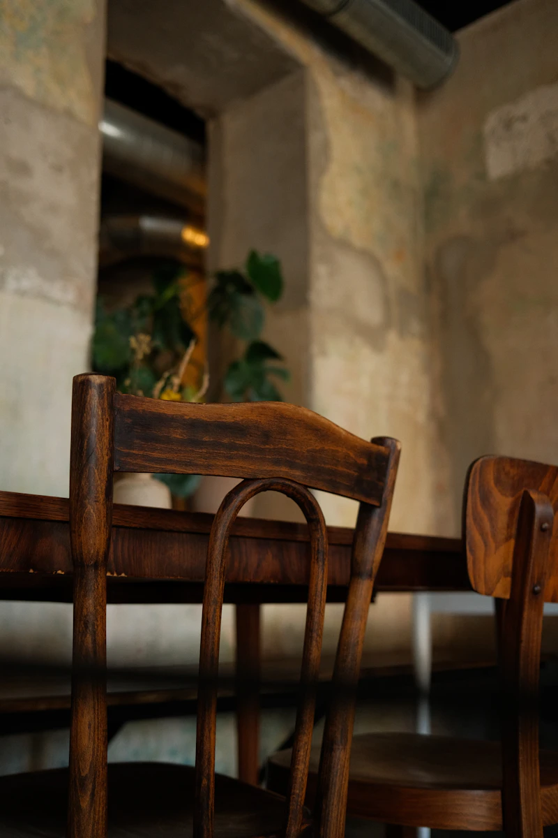 Two dark wooden chairs at a small table