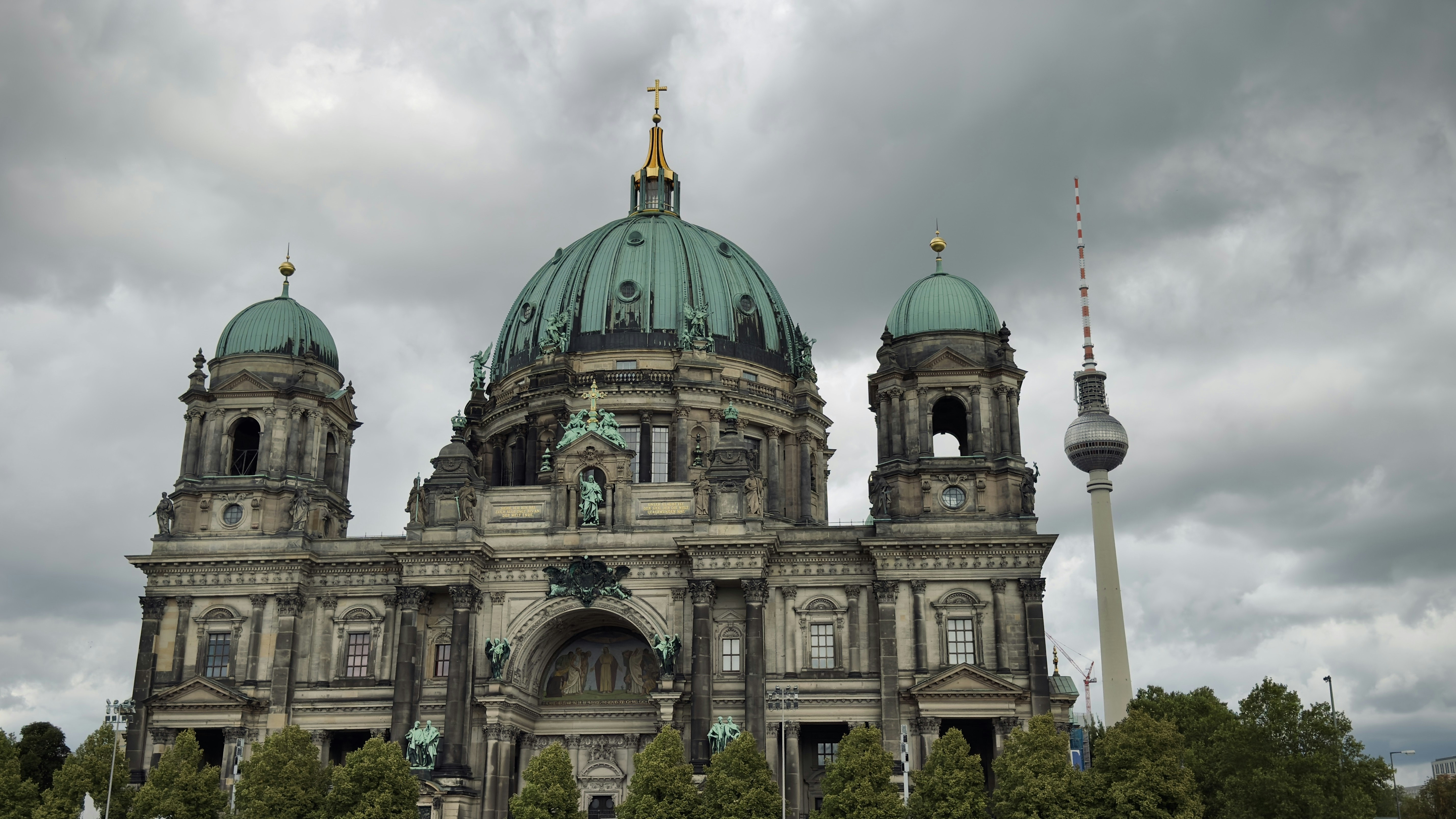 The Berlin Cathedral and the TV Tower under a cloudy sky in Berlin
