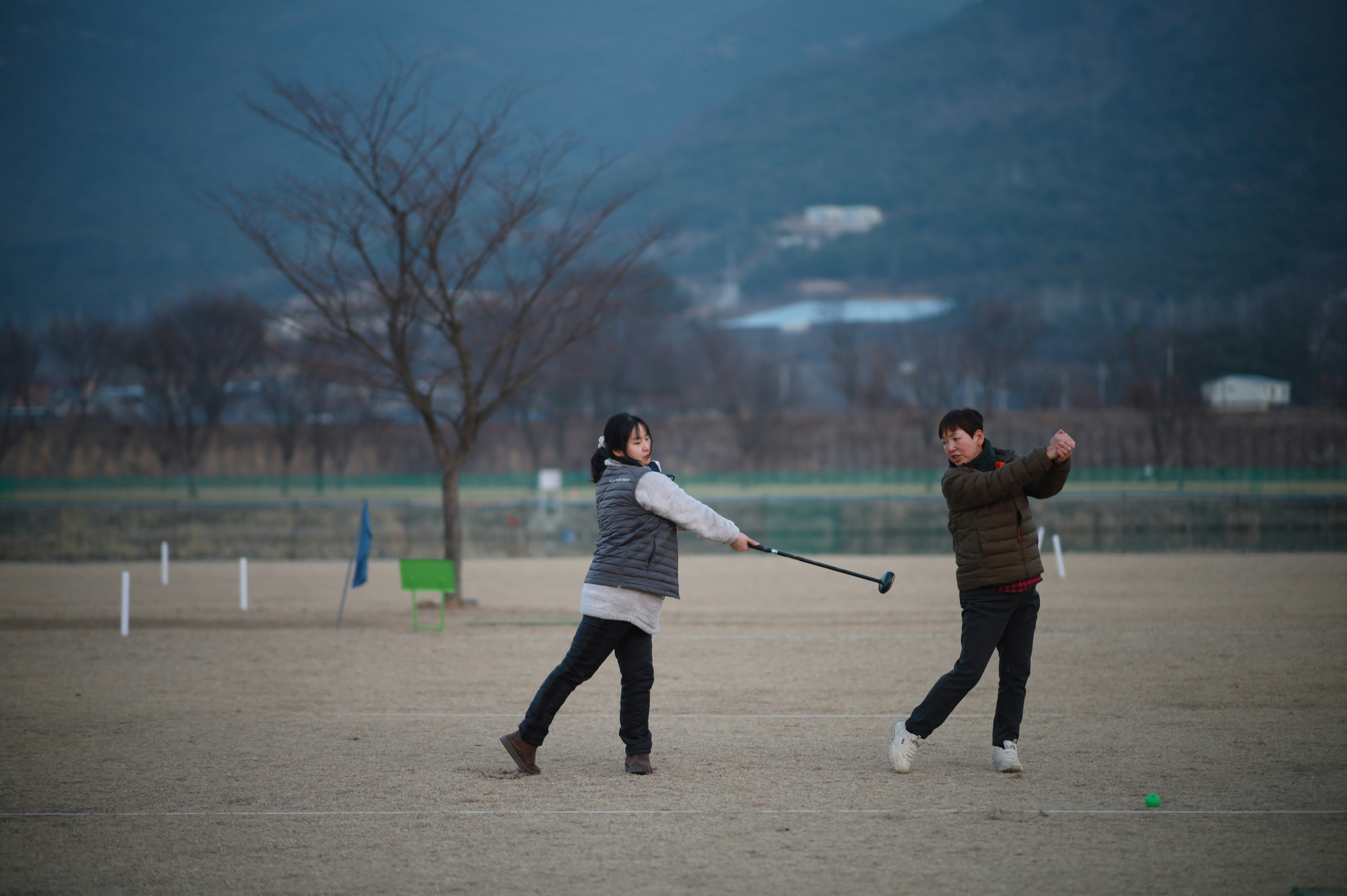 senior couple playing park golf