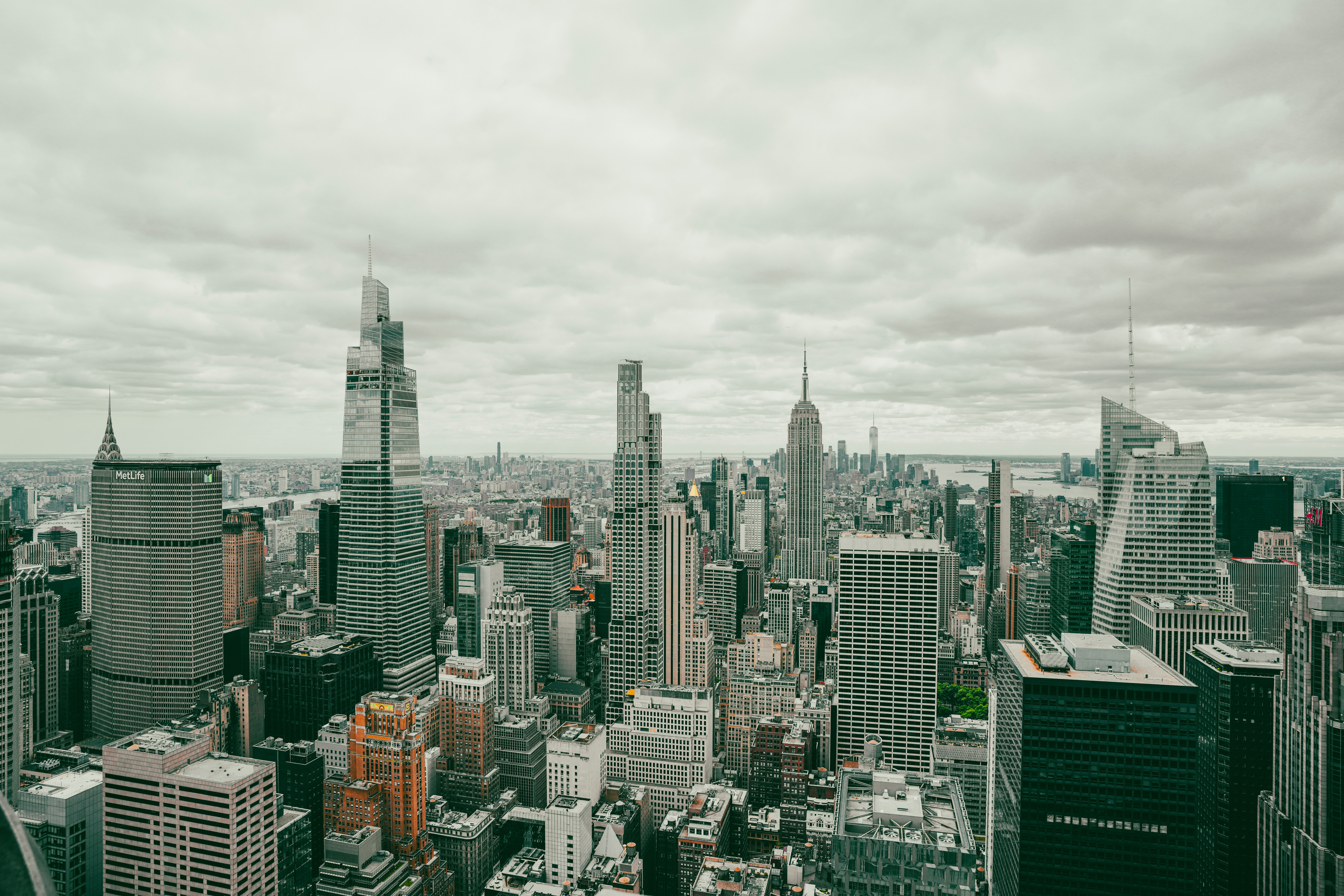 Aerial view of the dense Manhattan skyline under a cloudy sky in New York City