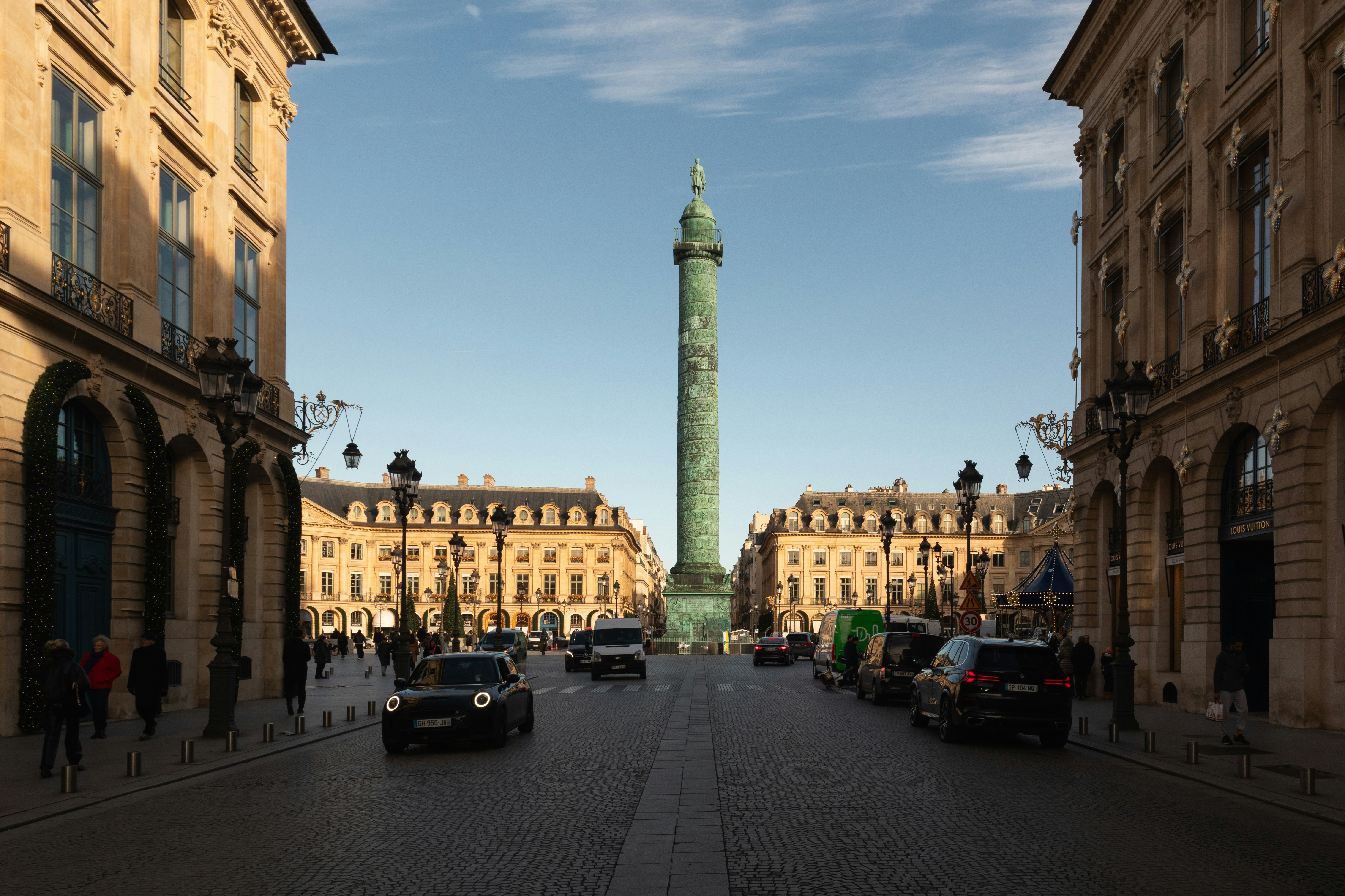 The Vendôme Column in the center of Place Vendôme in Paris with cars