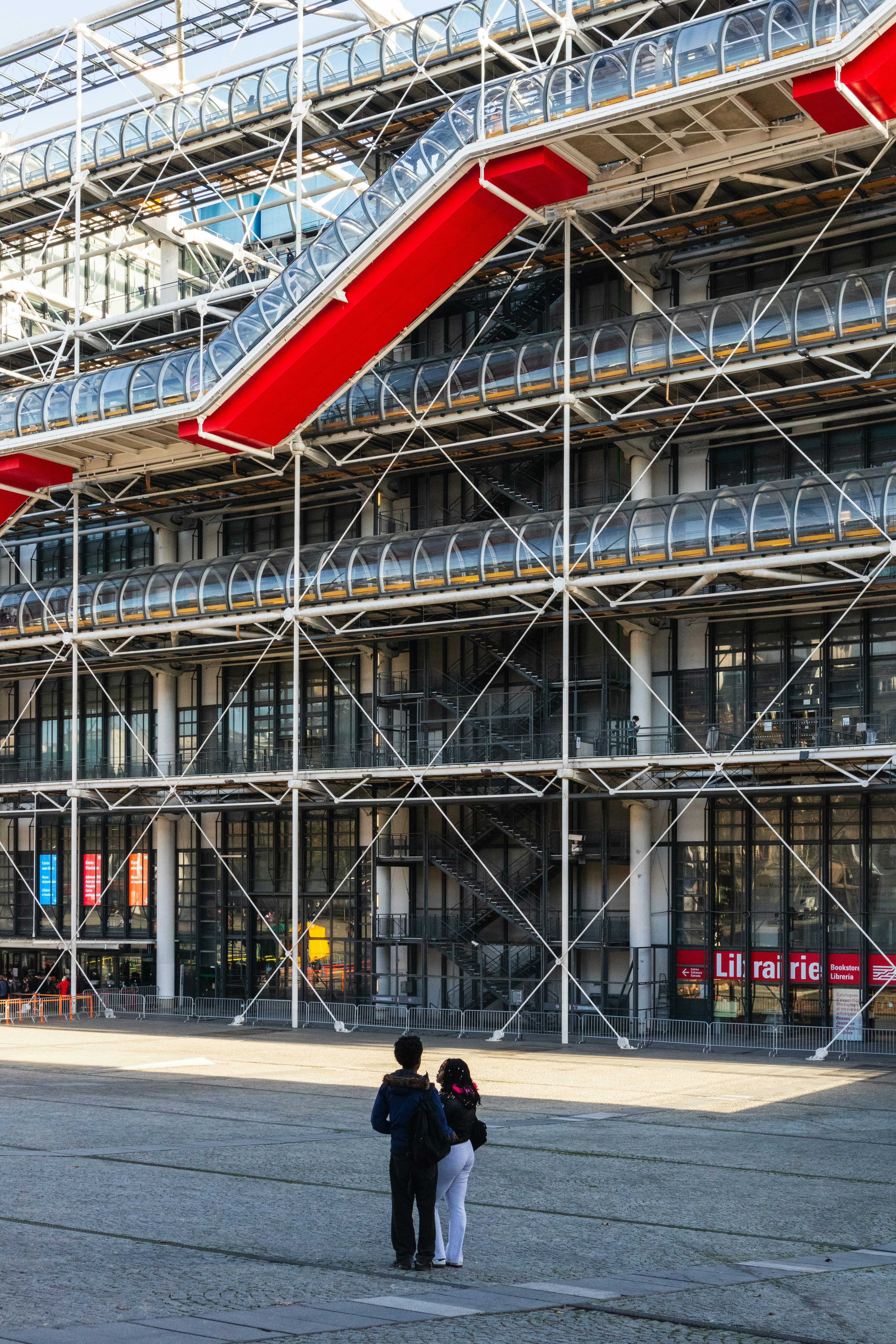 Two people standing in the plaza before the Centre Pompidou in Paris