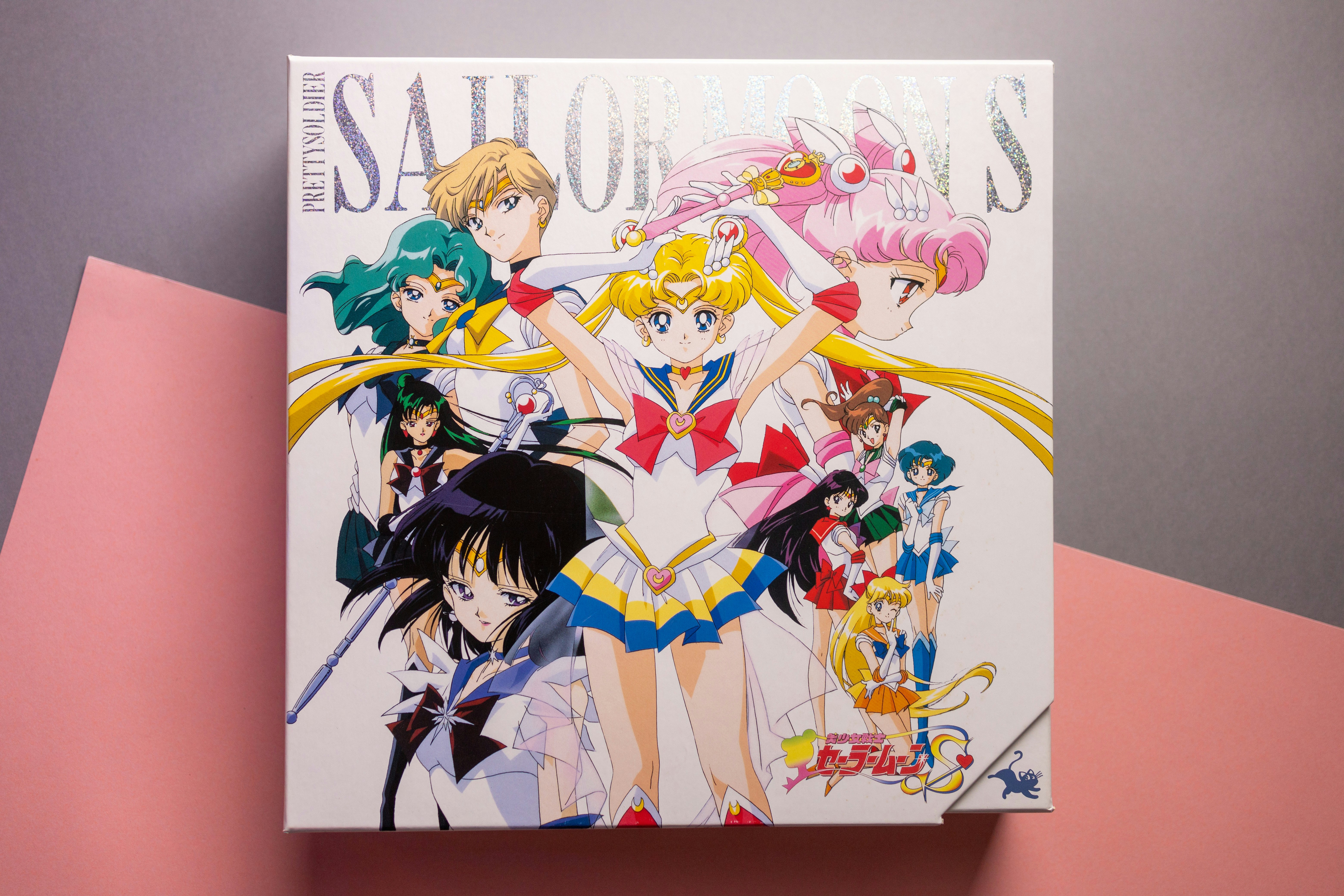 sailor moon wallpaper - A group of anime characters in colorful costumes on a white box cover