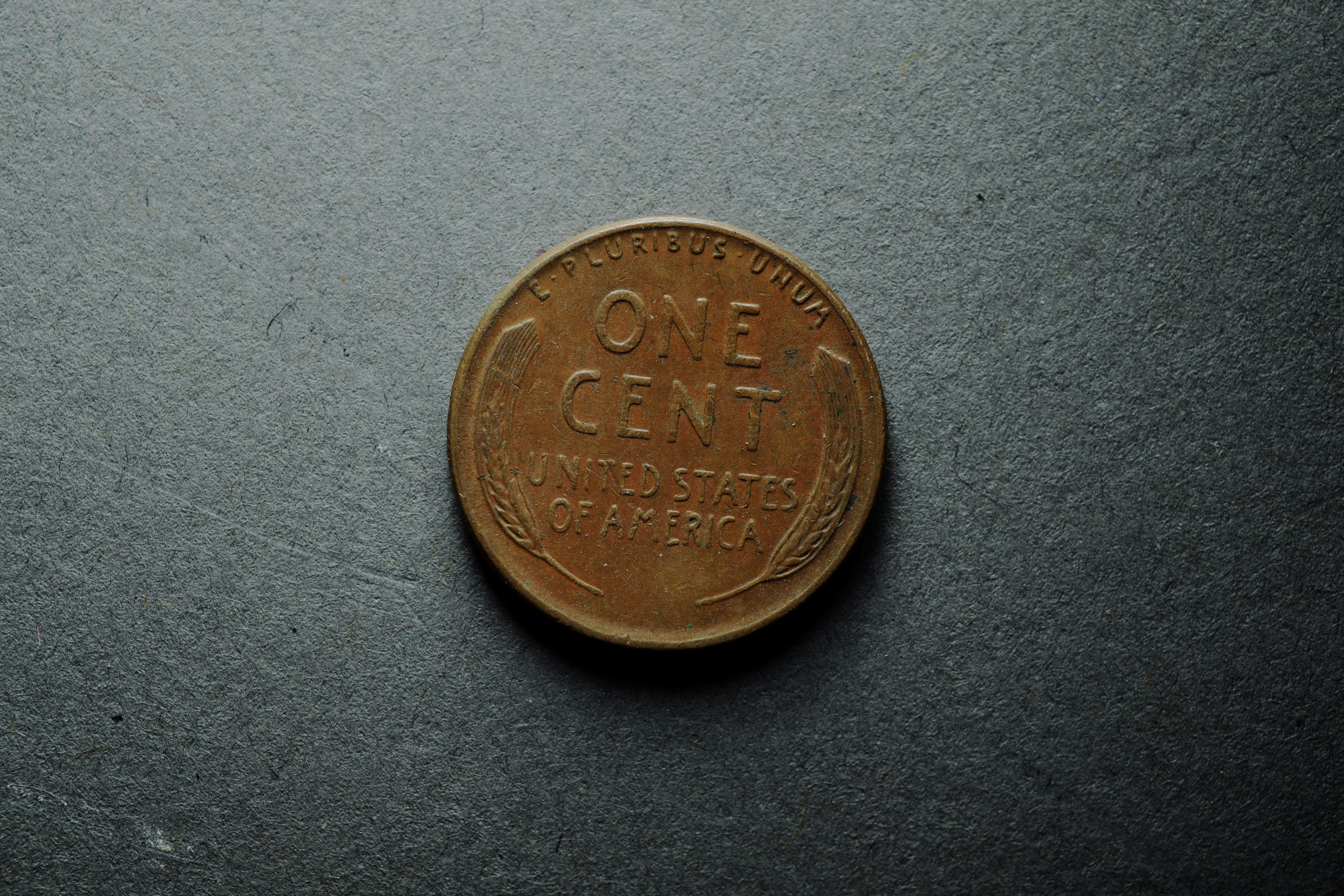 A vintage United States one cent coin on a dark textured surface