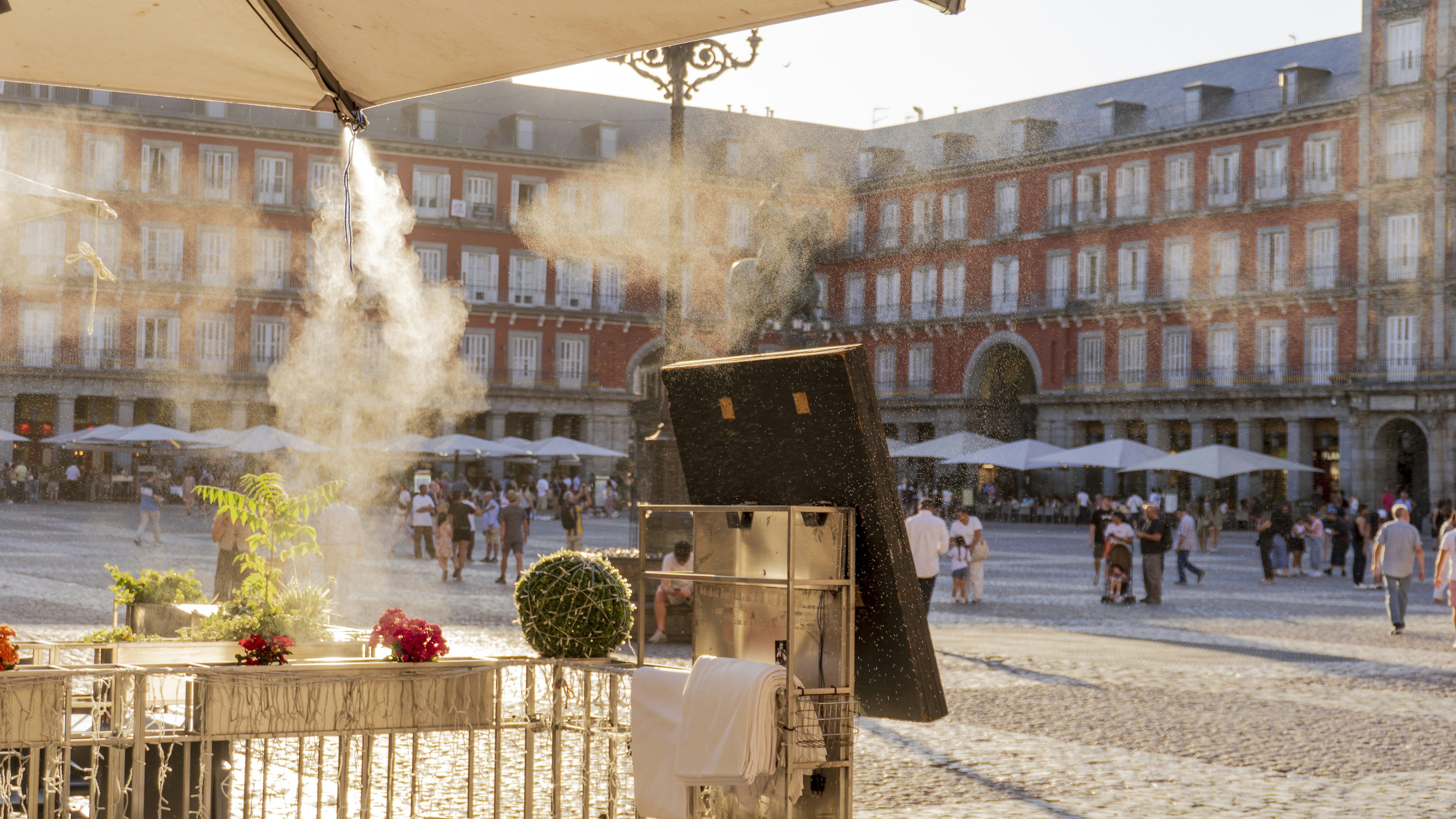 A misting system cooling an outdoor cafe in the Plaza Mayor in Madrid