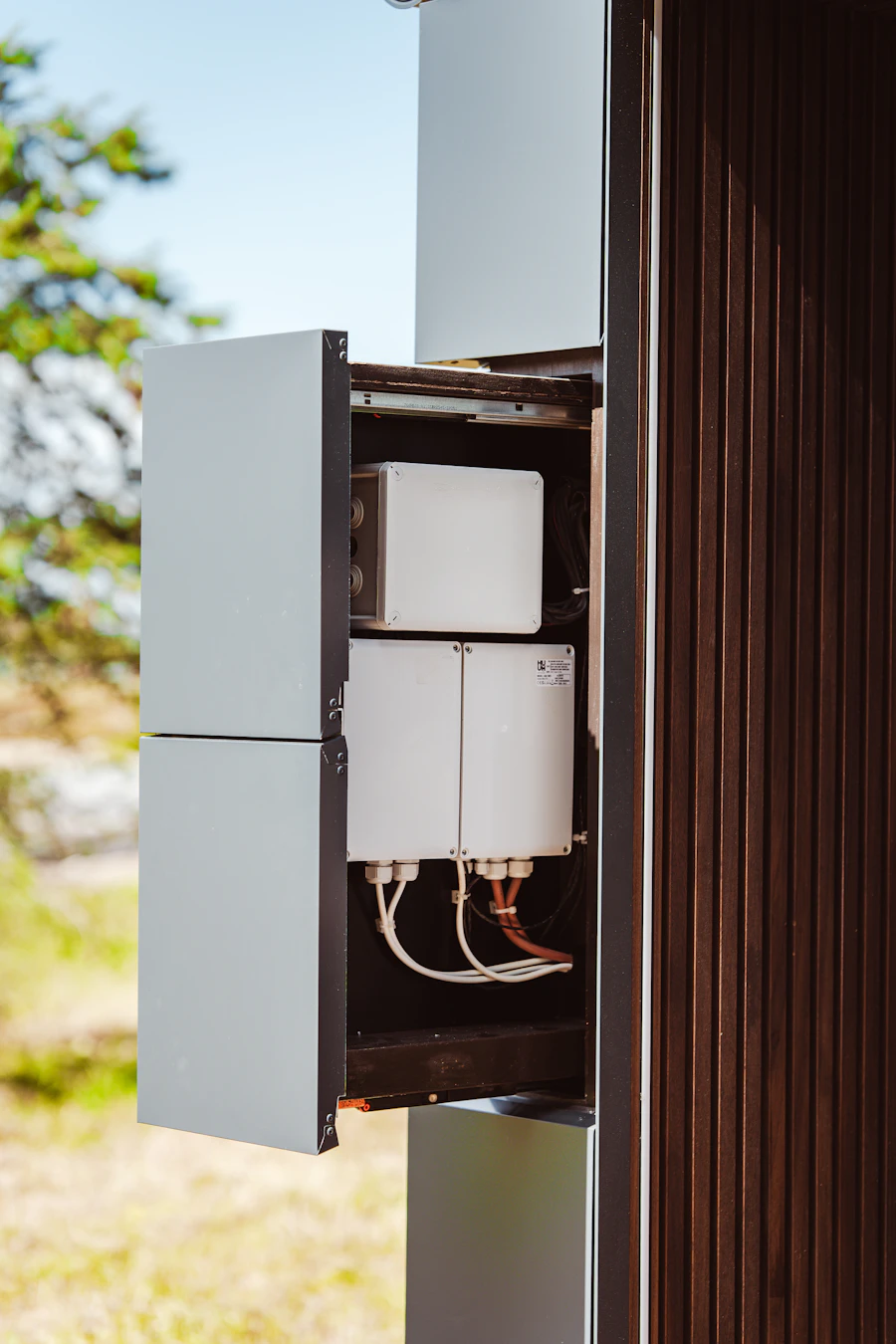 An open electrical enclosure on a post