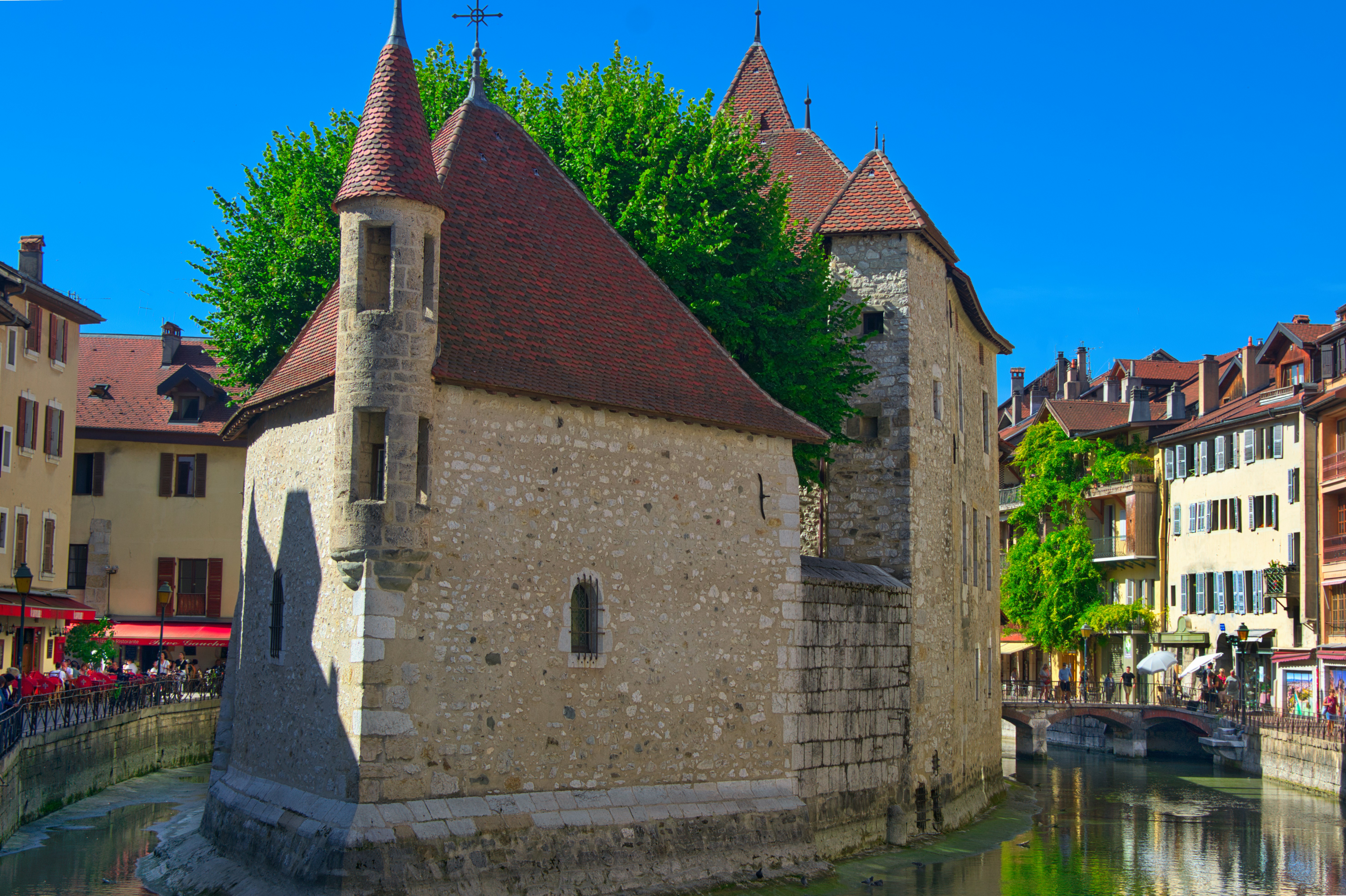 The Palais de l'Île stone fortress in a canal in Annecy, France