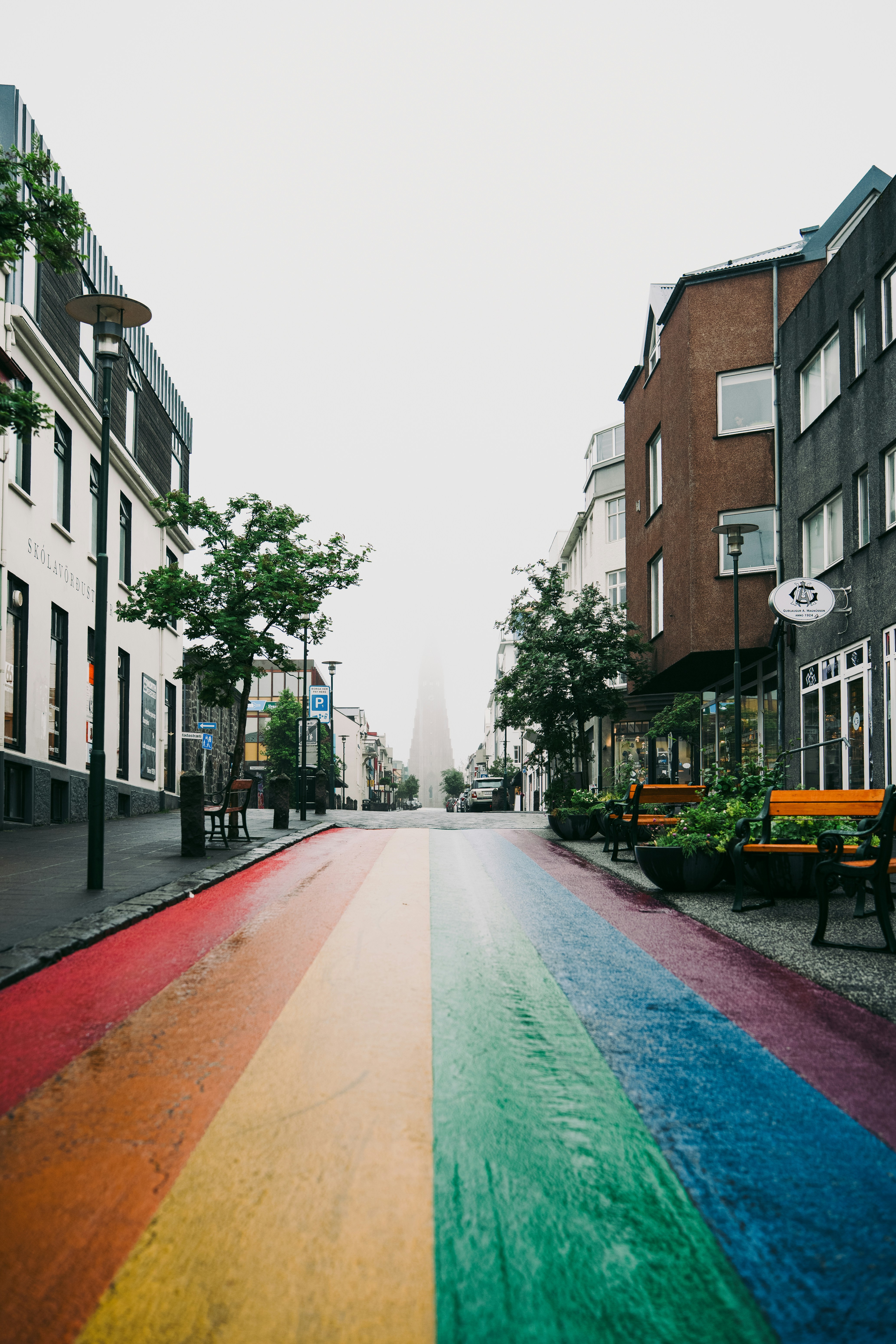 A rainbow painted street leading toward Hallgrímskirkja church in Reykjavik, Iceland