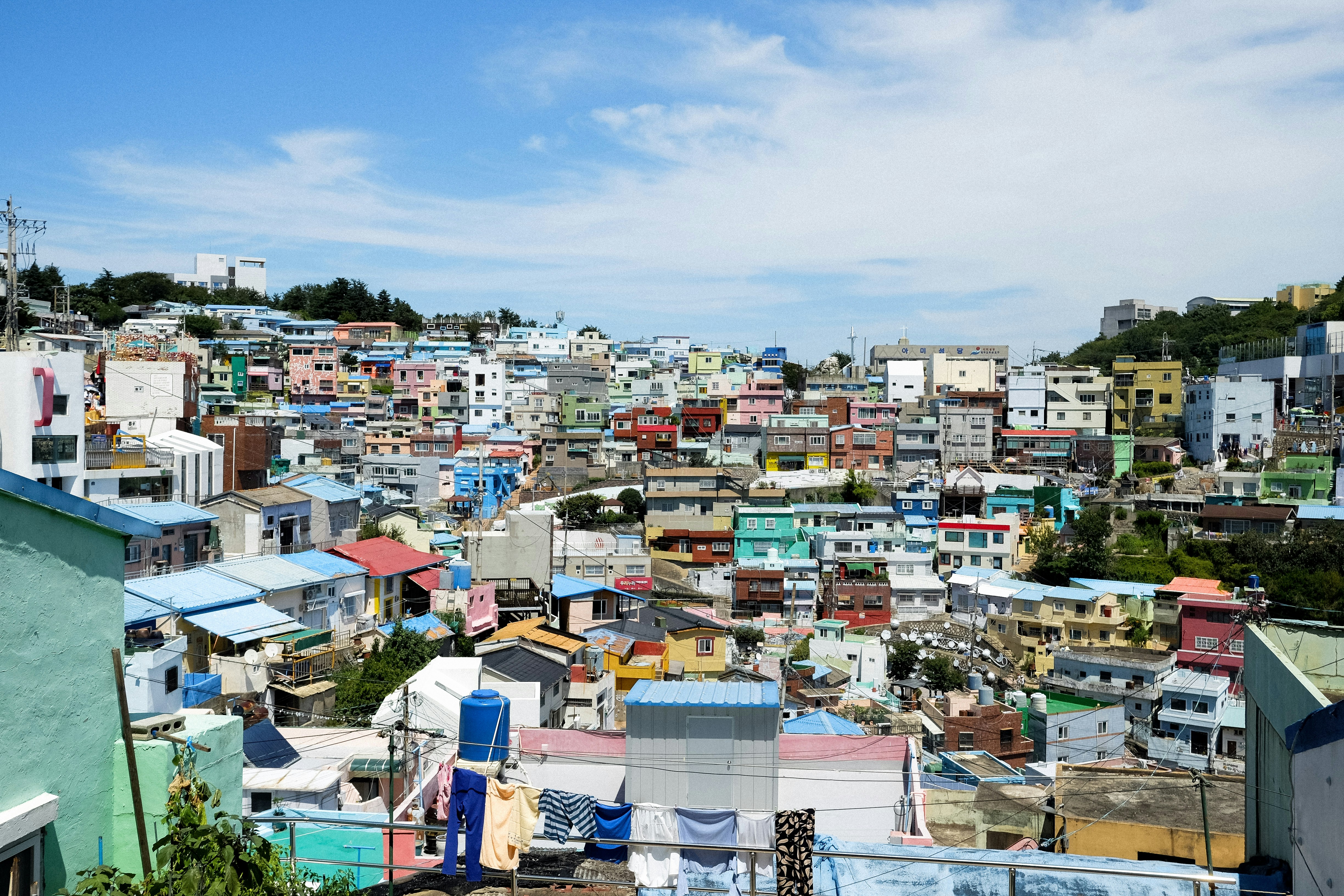 Colorful houses on a hillside in Busan, South Korea, with laundry hanging on lines