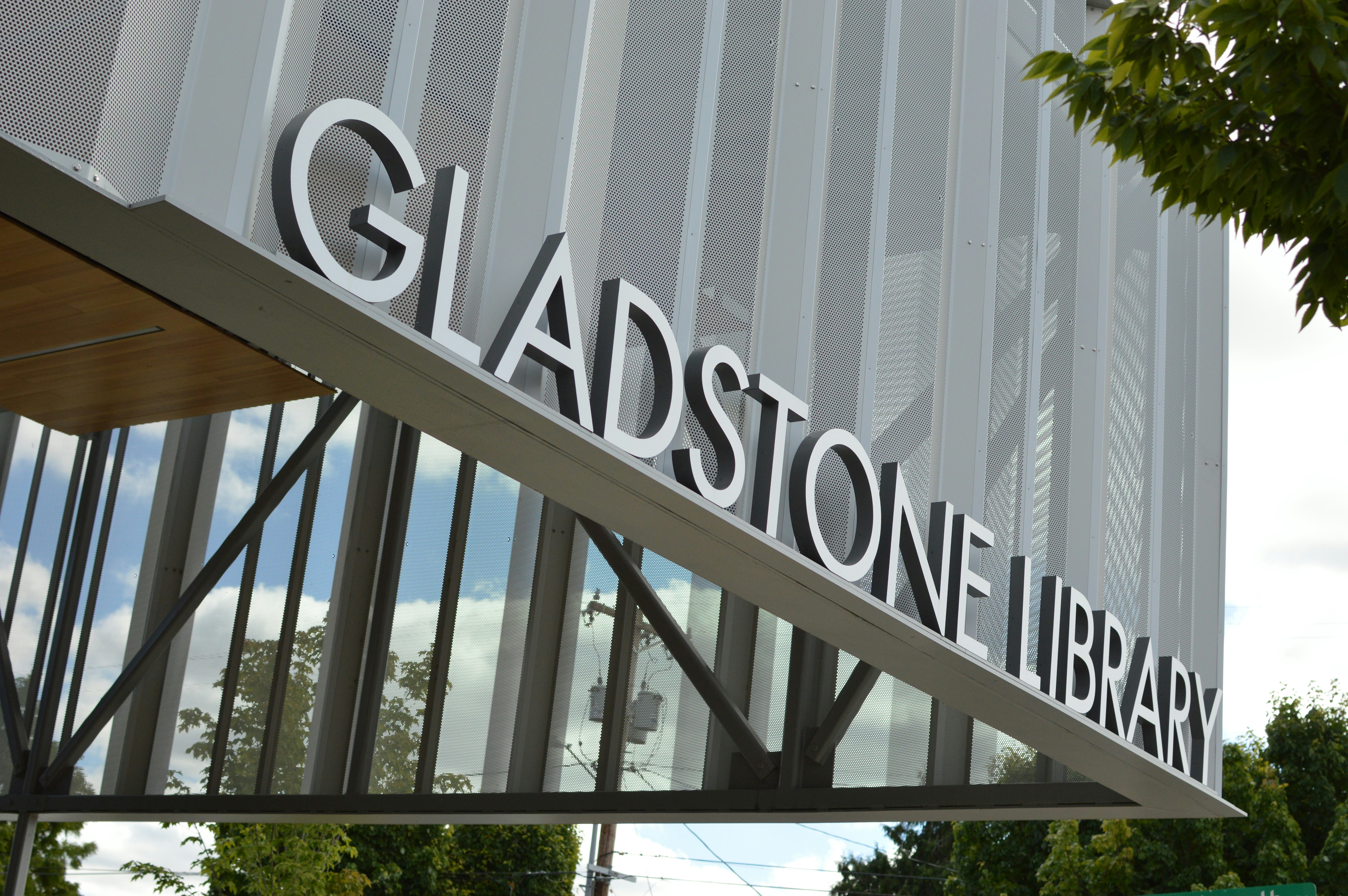 The Gladstone Library sign on a modern building with a perforated metal facade