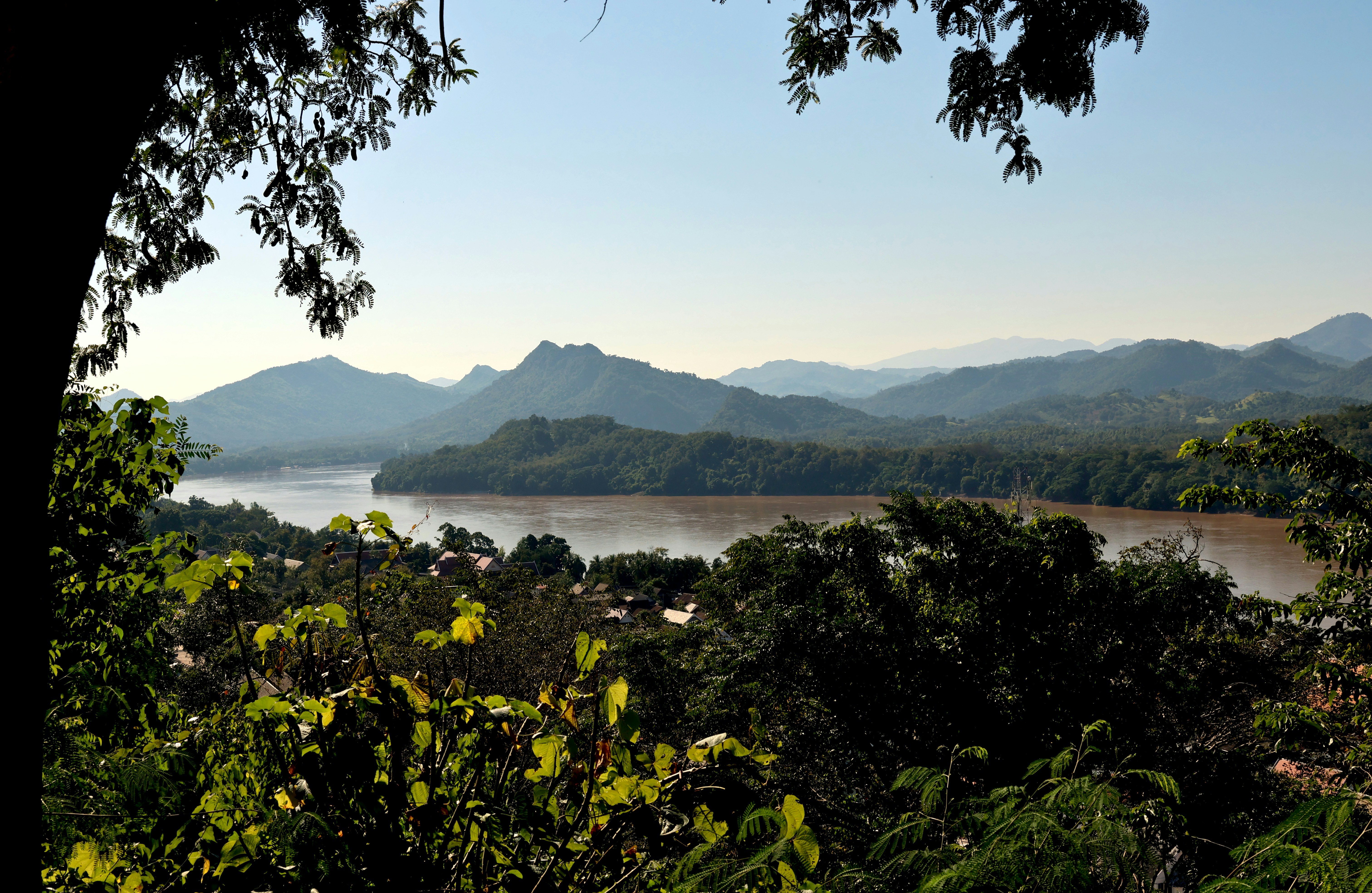 The wide, brown Mekong seen from Mount Phousi in Luang Prabang, between wooded hills and mountains