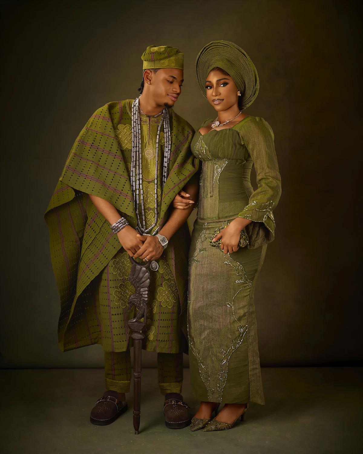 A Nigerian couple in coordinated olive green traditional wedding attire