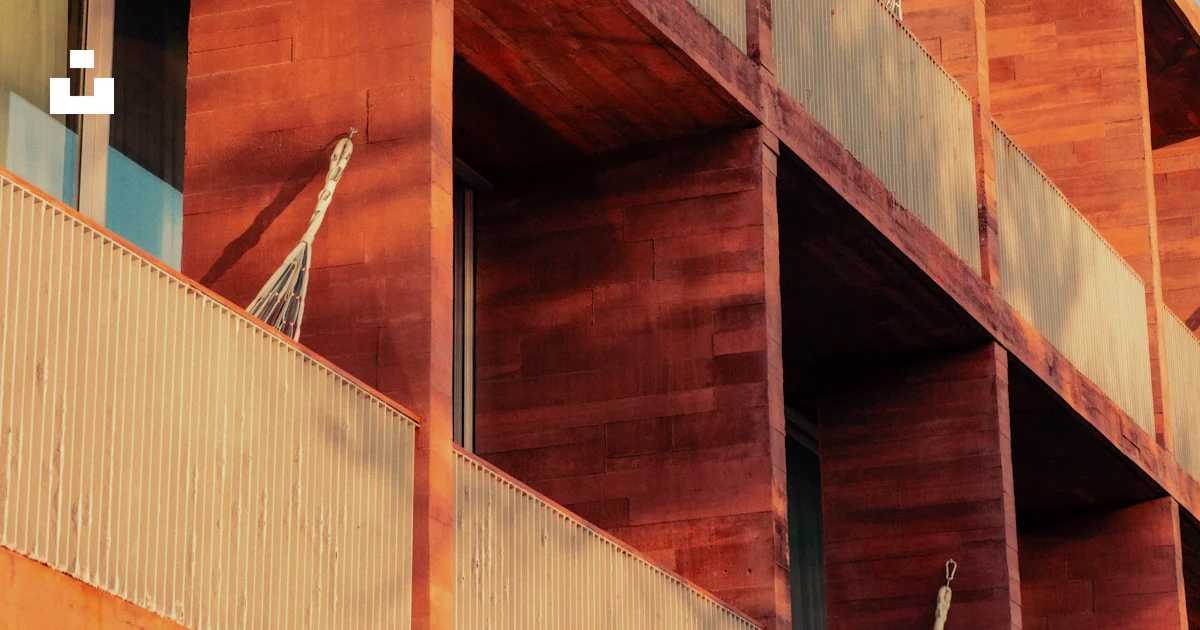 Building Farcade Red concrete building facade with balconies - Free Photo on Unsplash