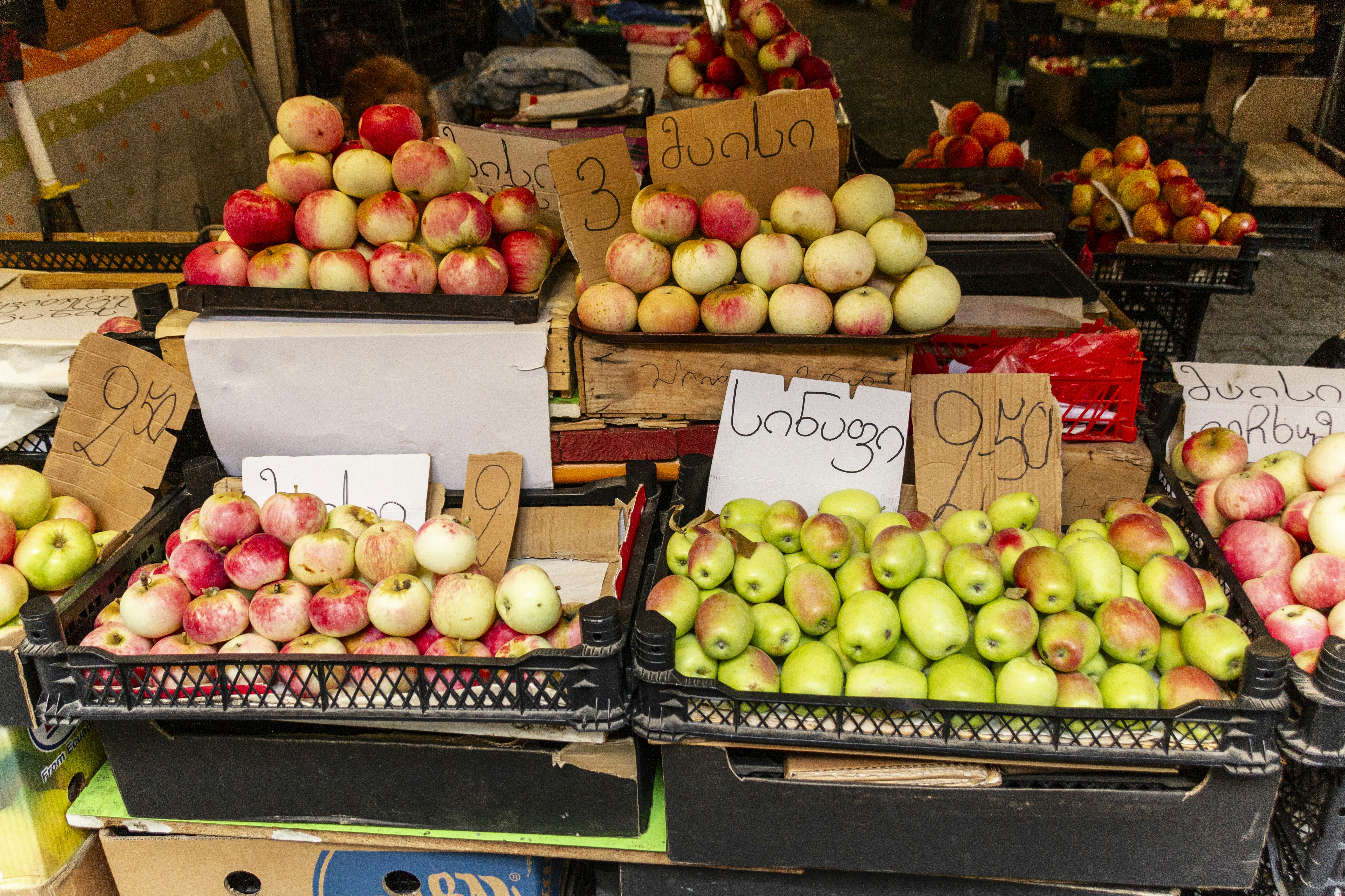 Red and green apples at a market stall