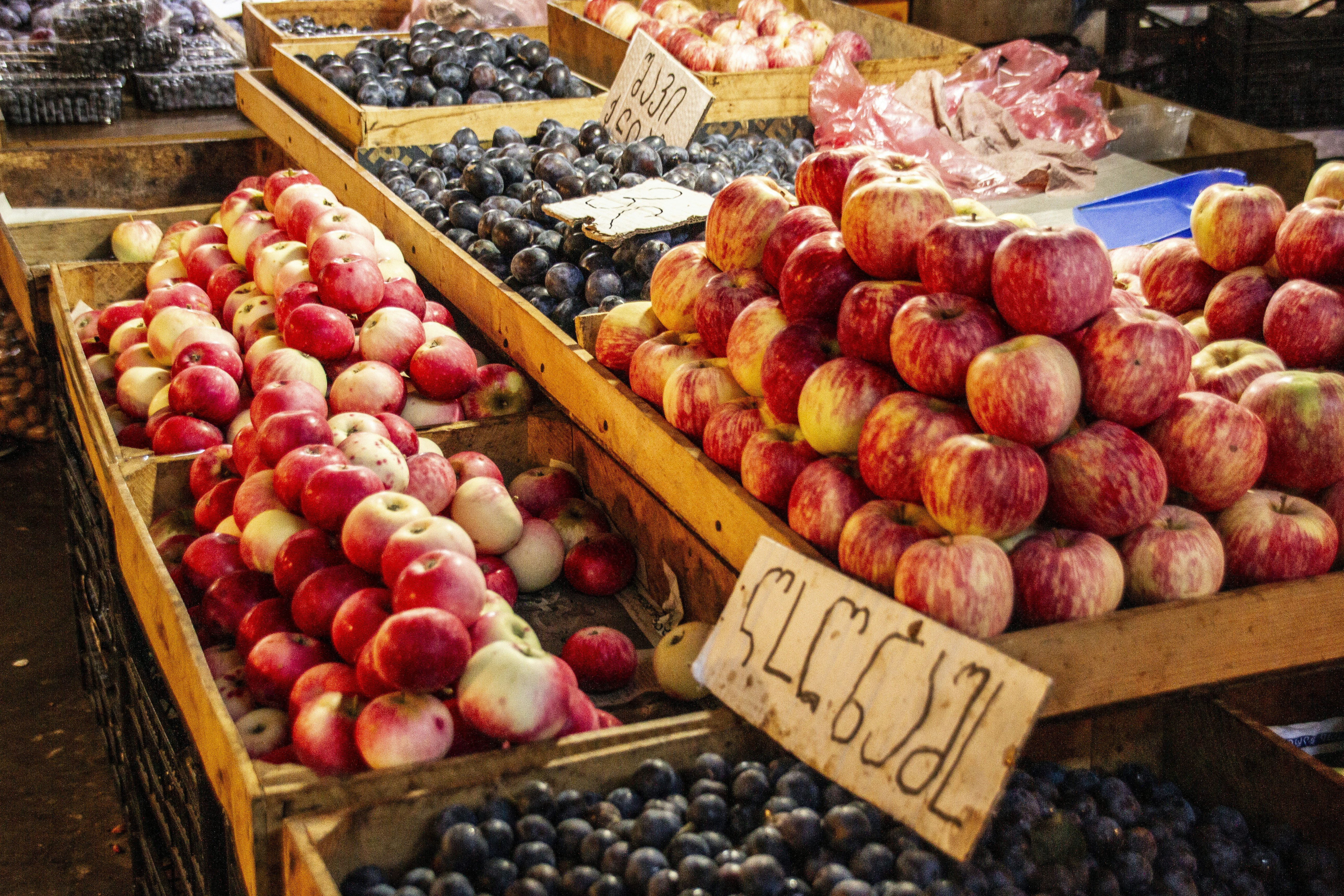 Wooden crates of red apples with a price tag