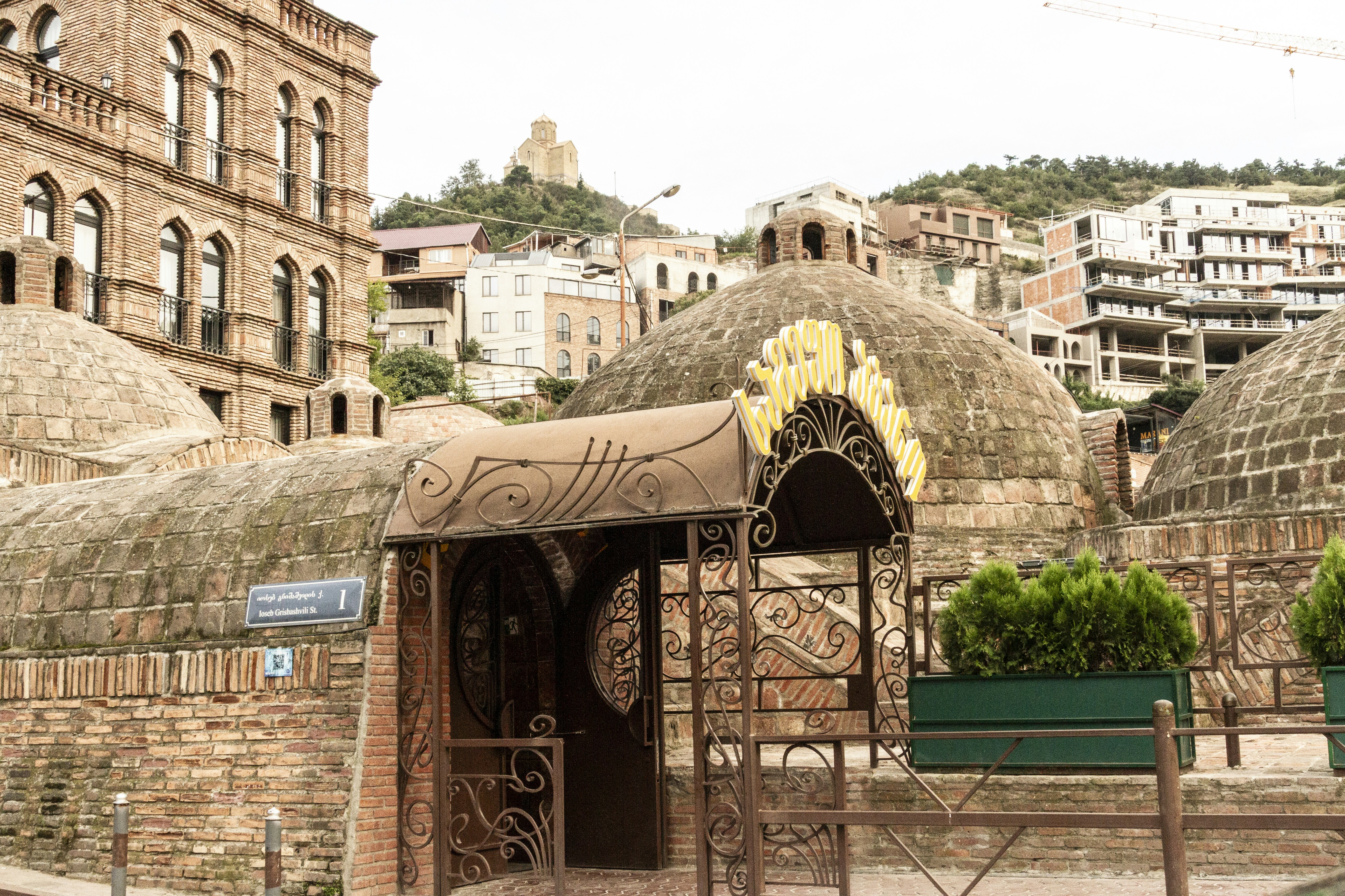Brick domes and an ornate metal entrance in the Abanotubani district of Tbilisi