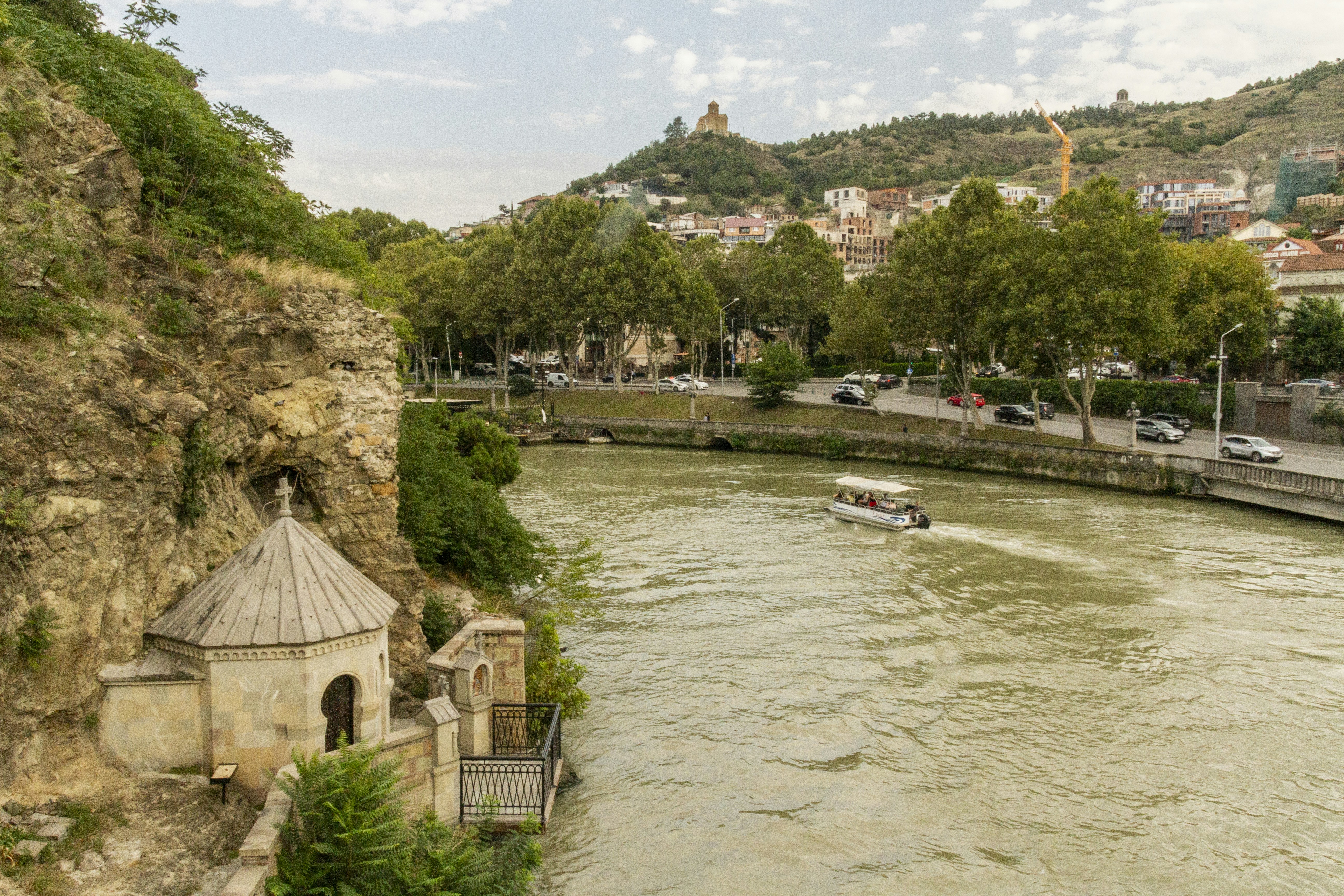 A small stone chapel built into a cliffside above the Kura River in Tbilisi