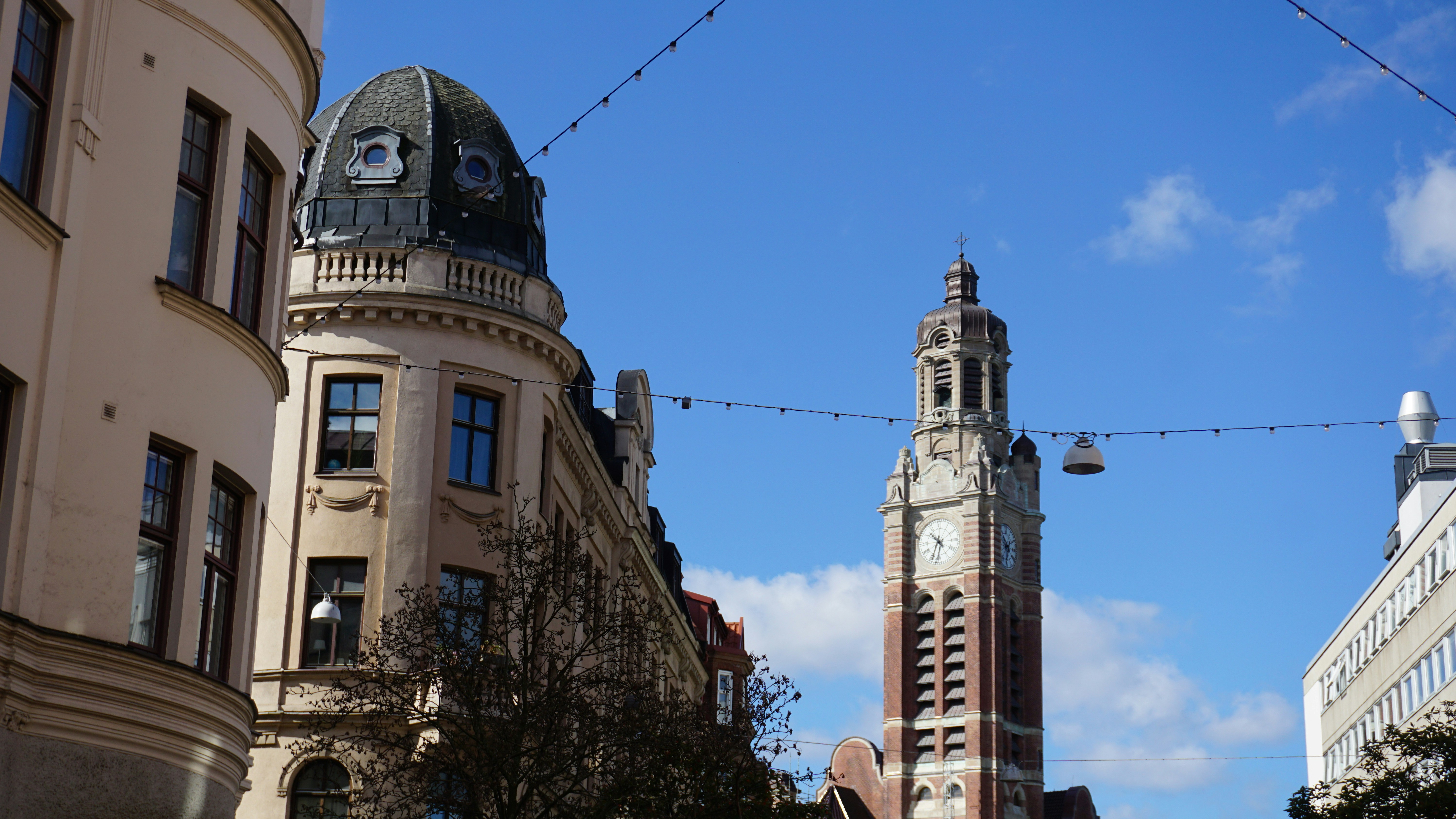 Clock tower above historic buildings - Free Photo on Unsplash