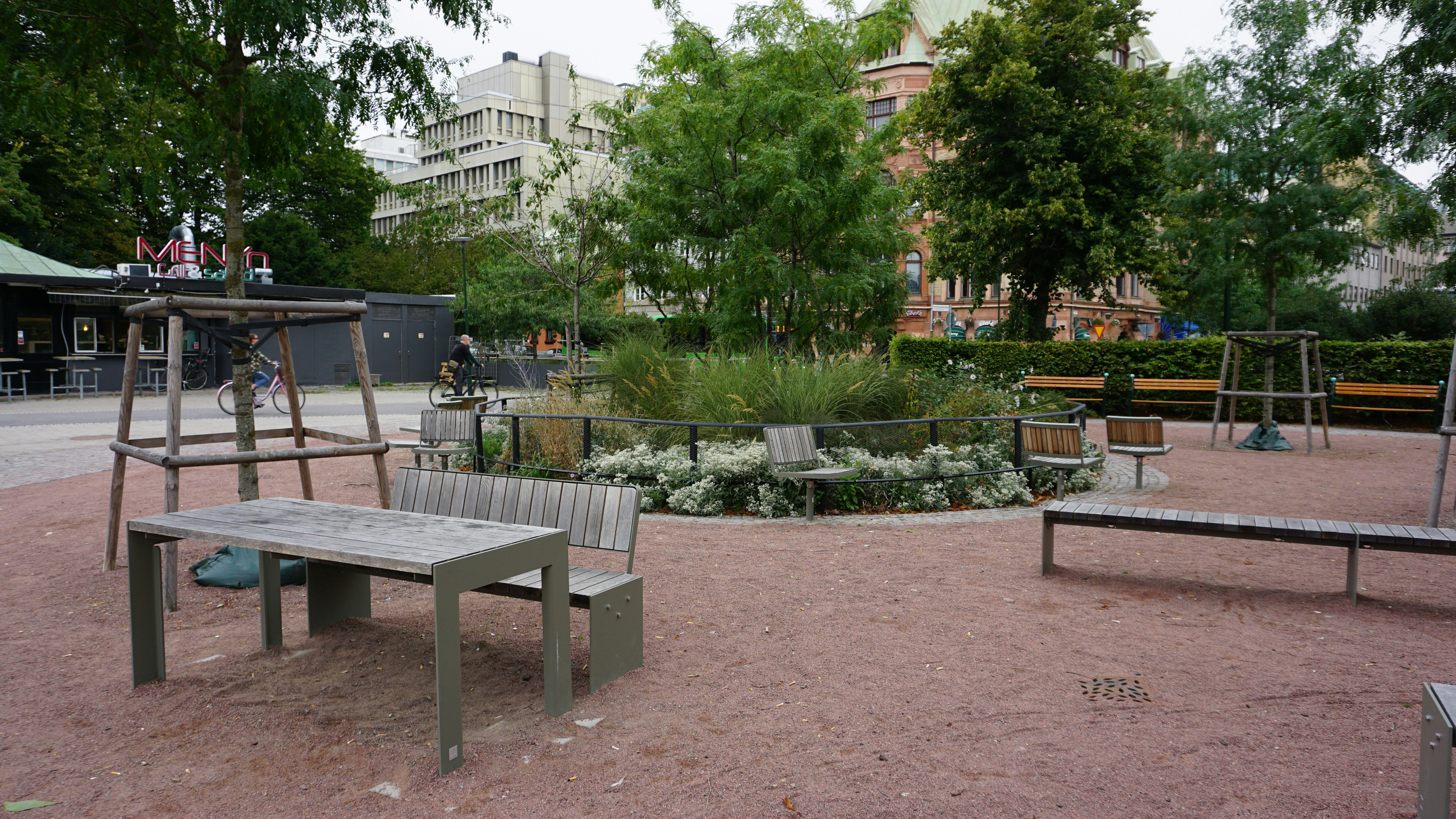 Benches and table on a gravel area in a city park