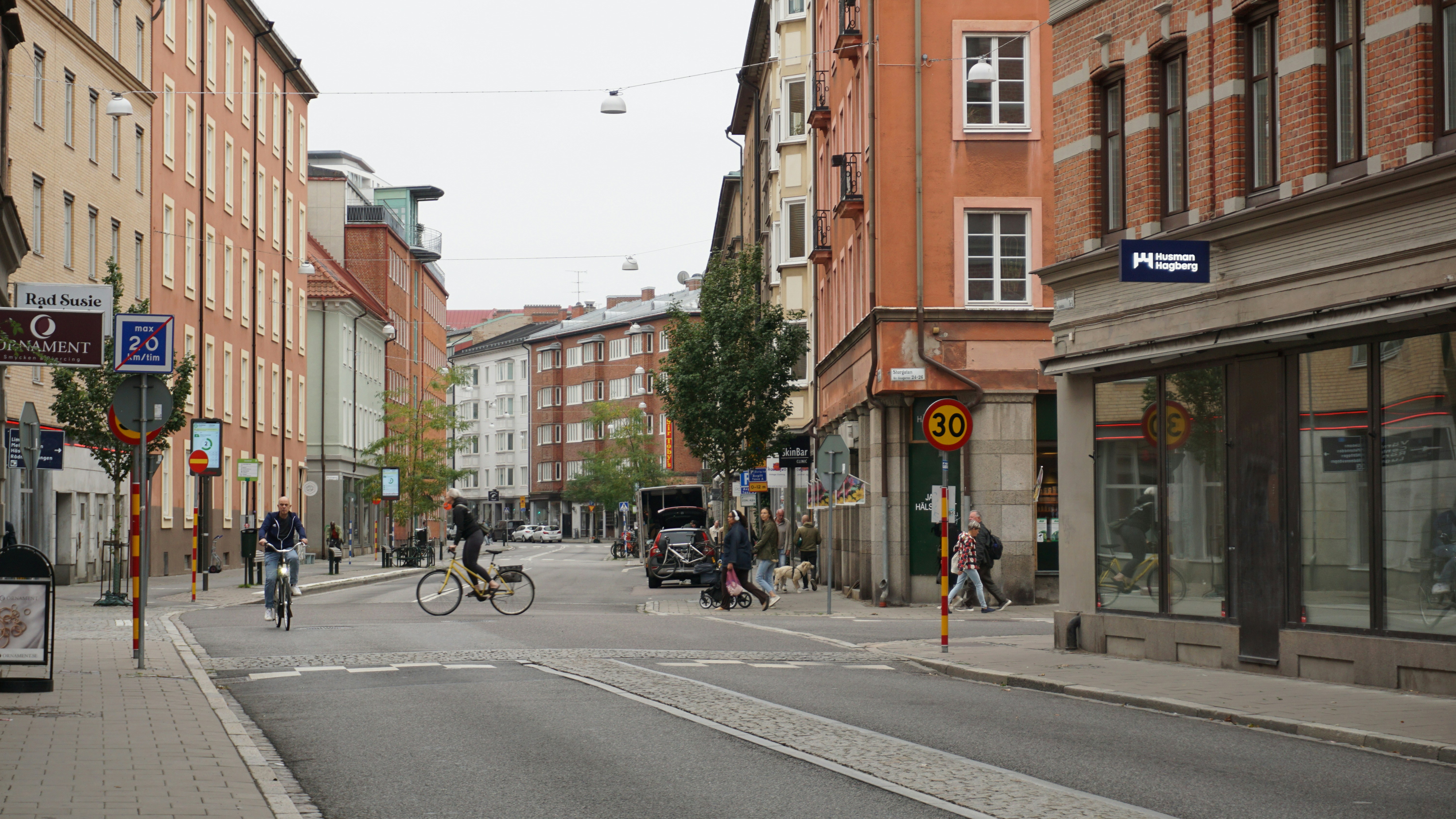 People cycling and walking on a city street