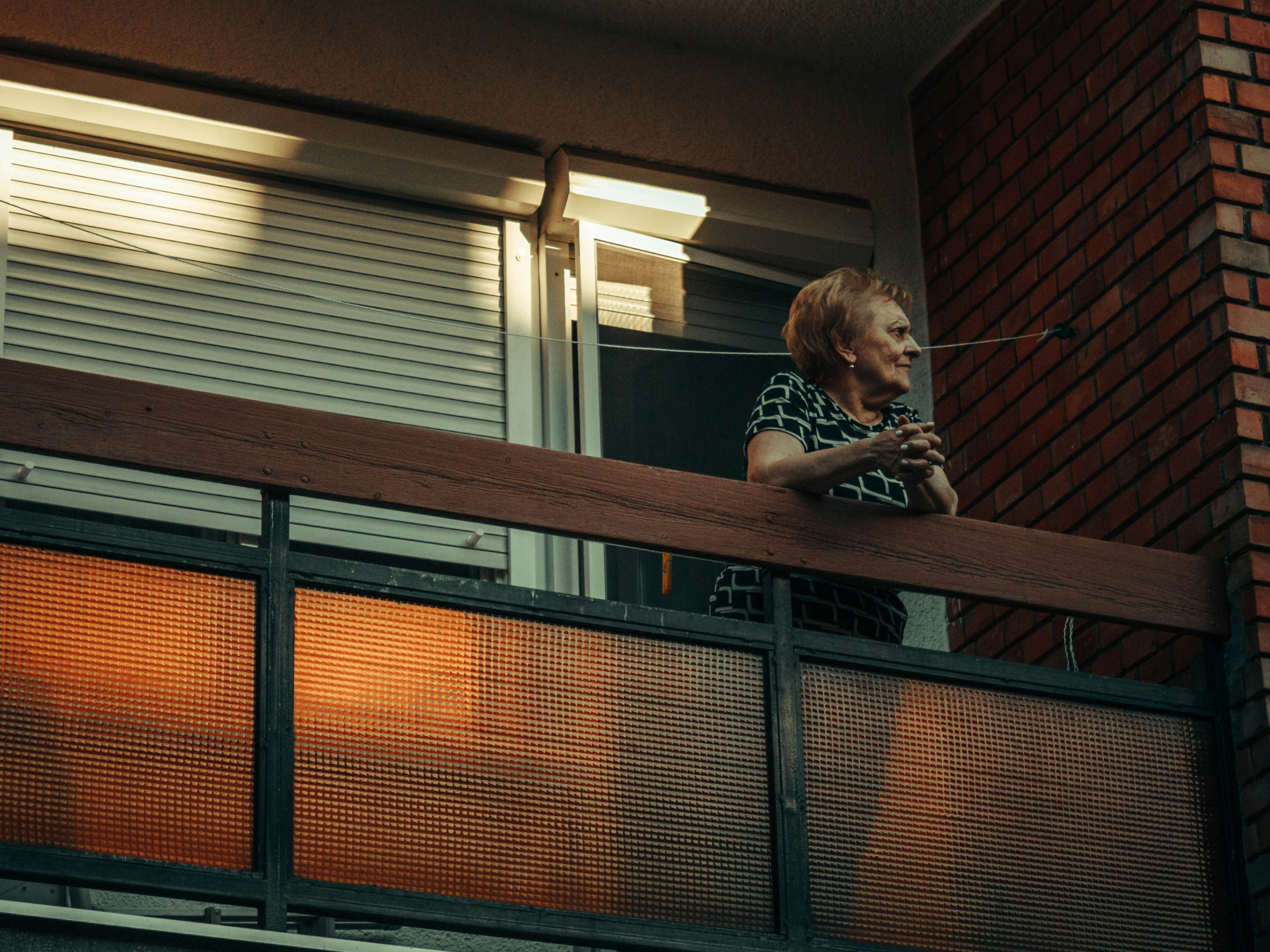A person stretching gently in the morning sun on a balcony