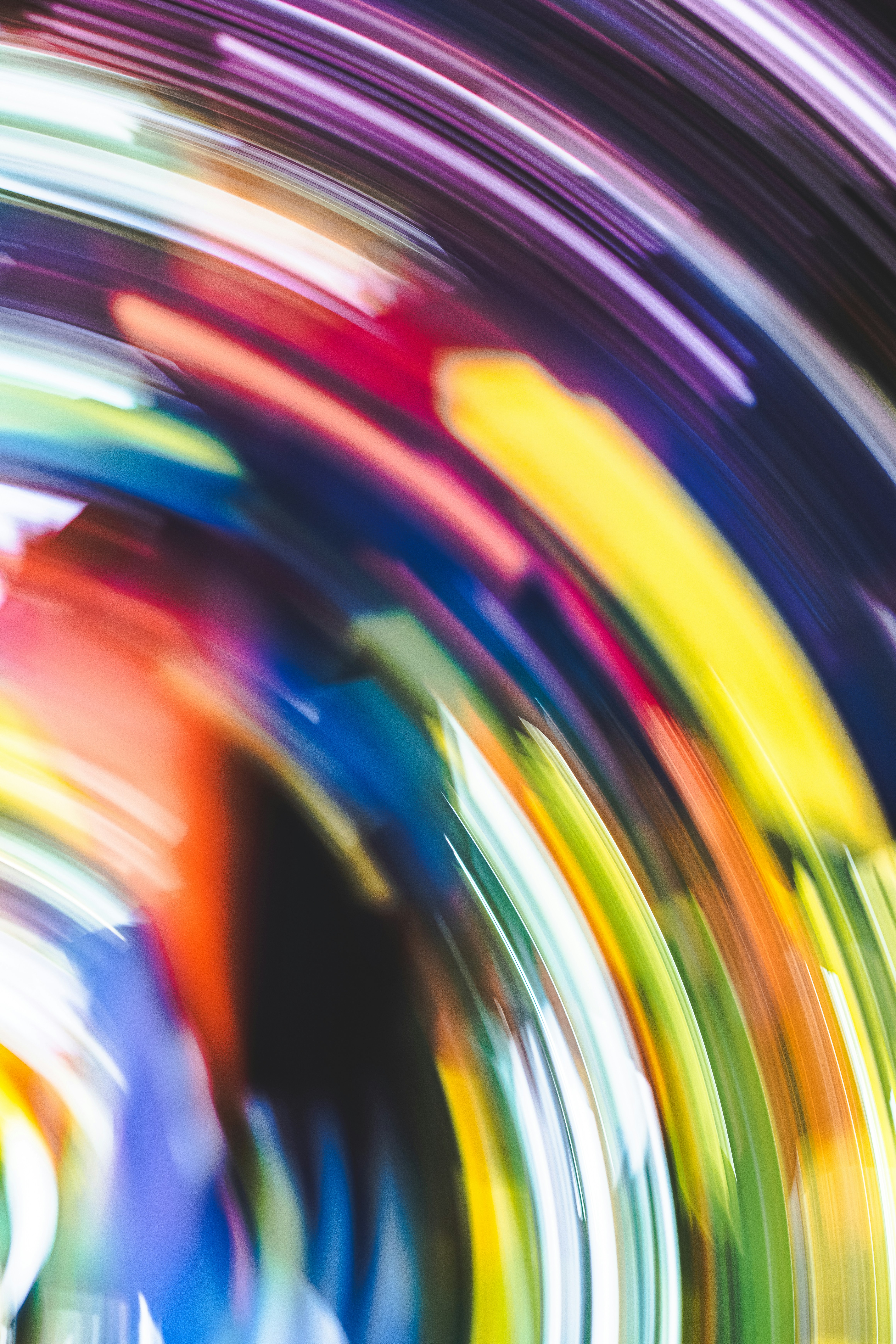 Abstract long exposure light trails in vibrant yellow, red, blue, and purple