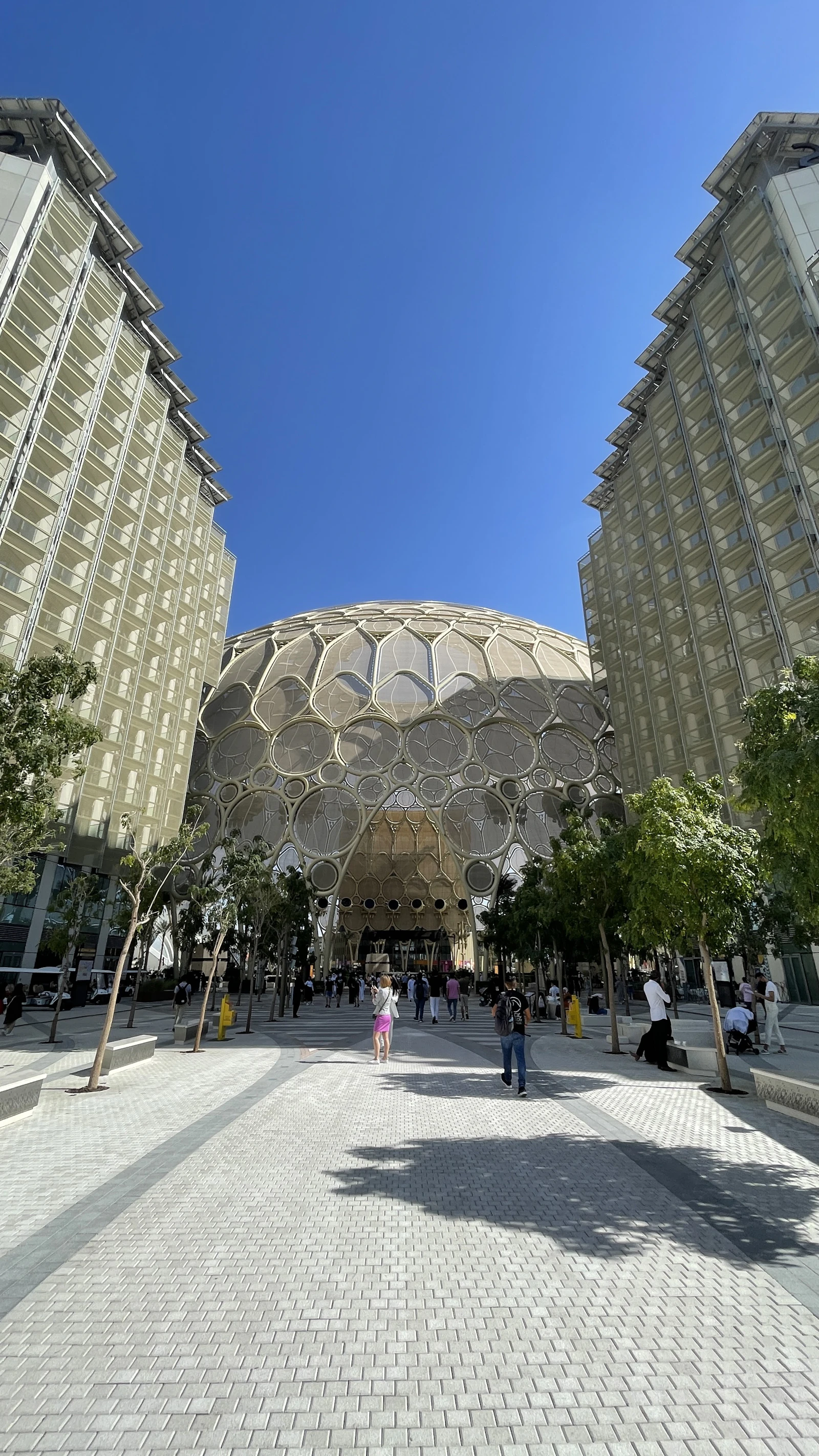 Visitors walking across the plaza towards the Al Wasl dome at Expo City Dubai