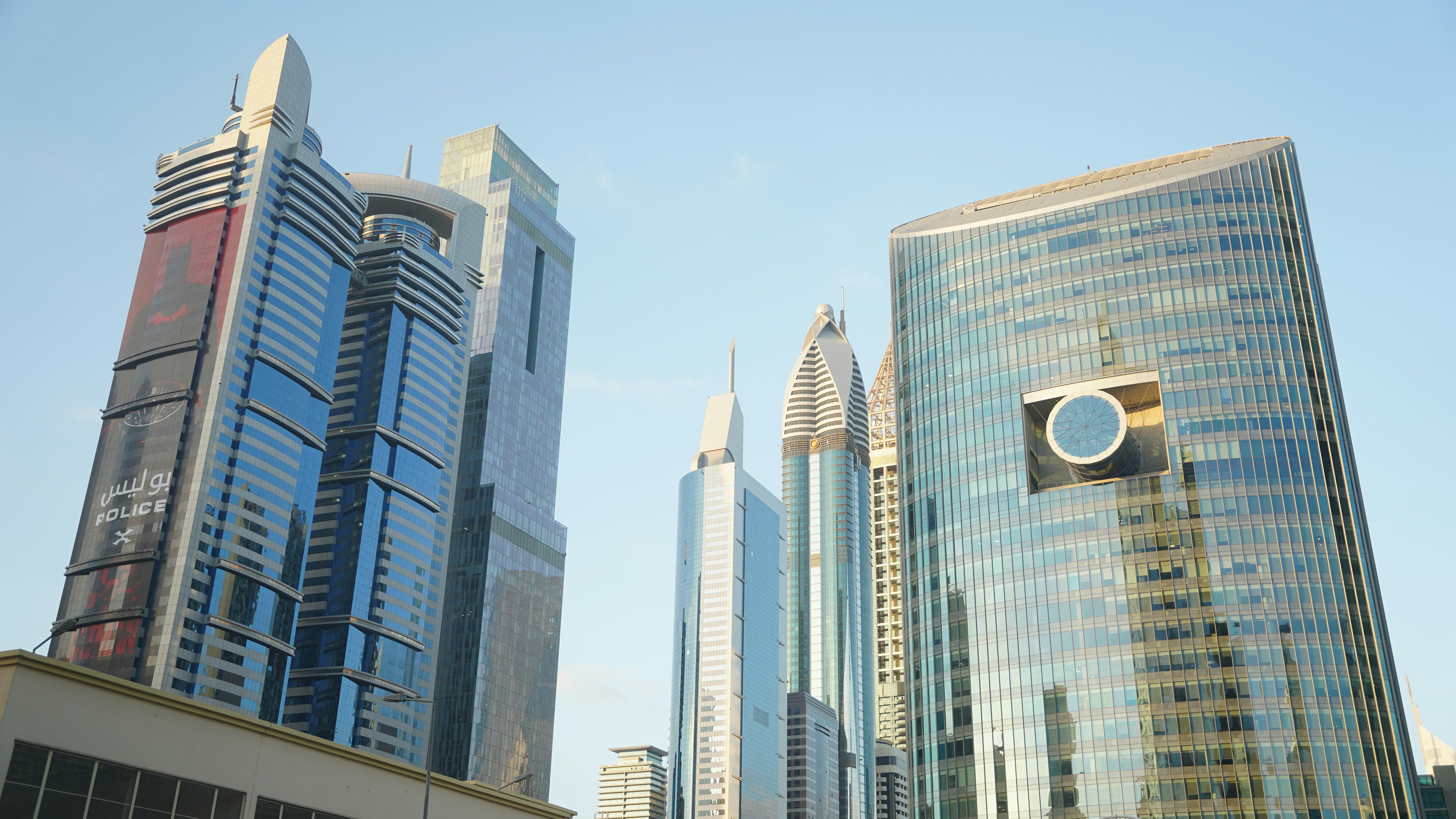 Modern glass skyscrapers under a clear blue sky in Dubai